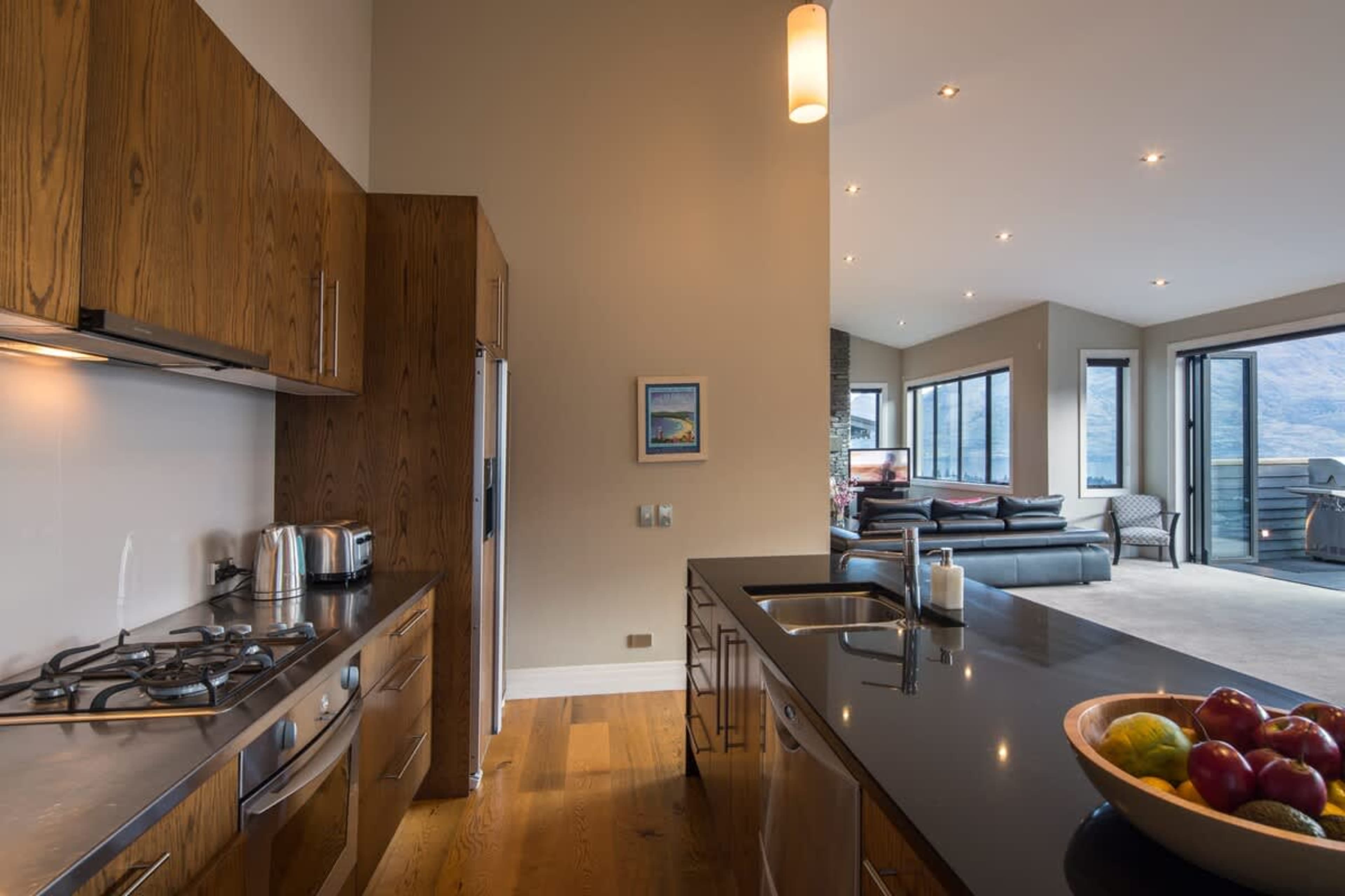 Fully Equipped for Your Stay: This sleek, contemporary kitchen features all the modern conveniences, including a dishwasher, coffee machine, and high-quality appliances.