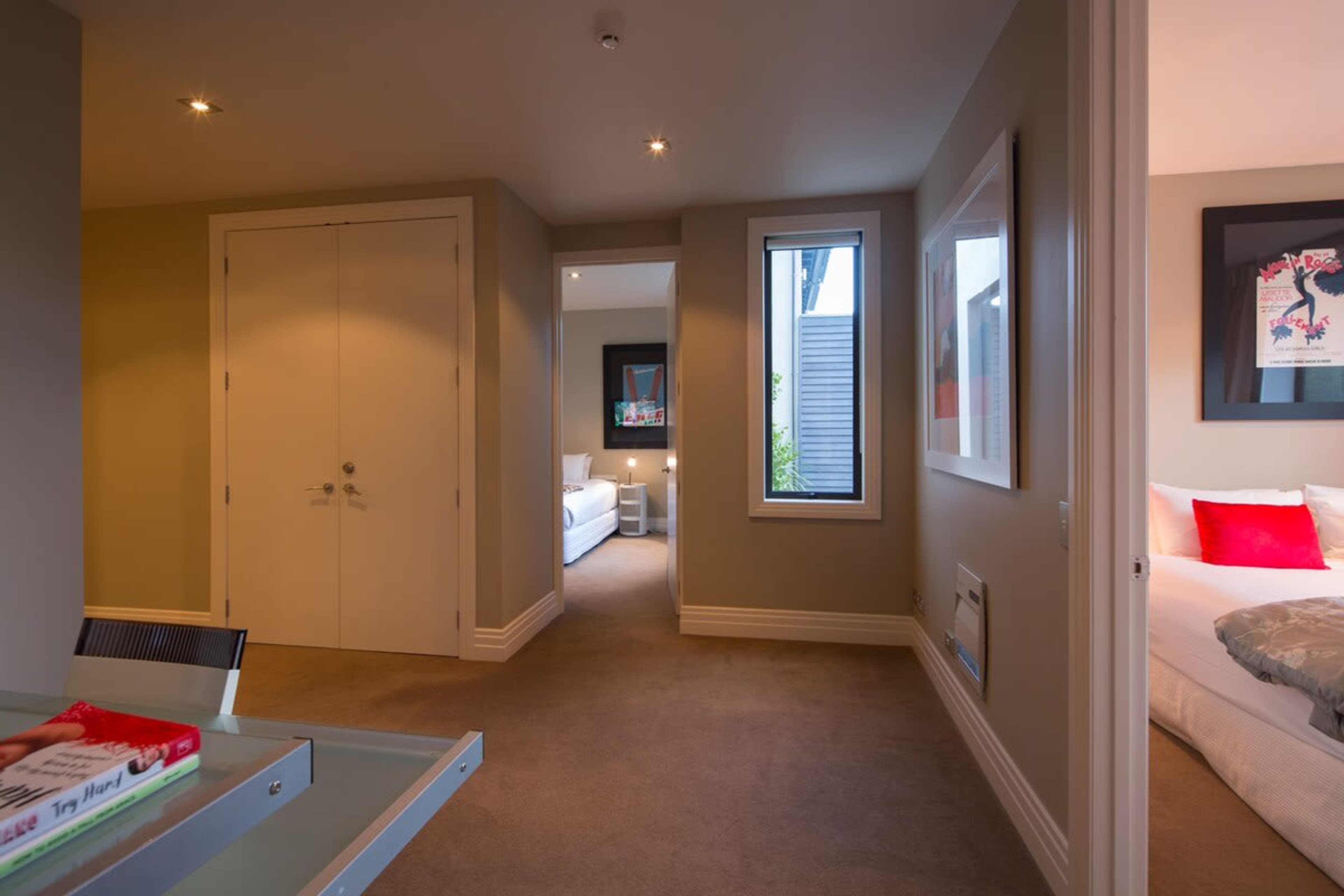 Spacious hallway leading to bedrooms with a desk available during your Queenstown stay