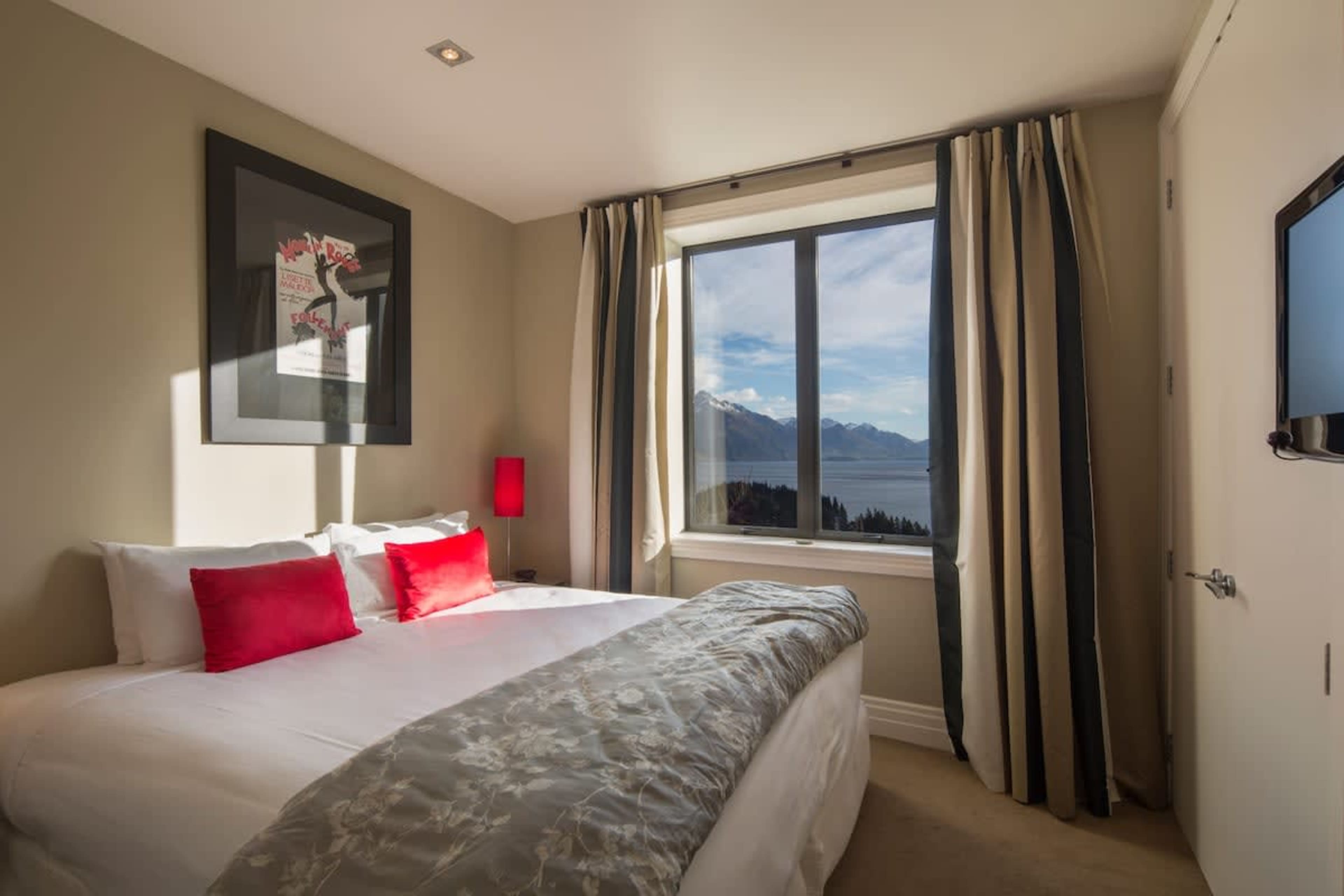 Cozy Second Bedroom with a View: Wake up to stunning lake and mountain vistas in this serene space, complete with comfortable bedding for a restful stay.