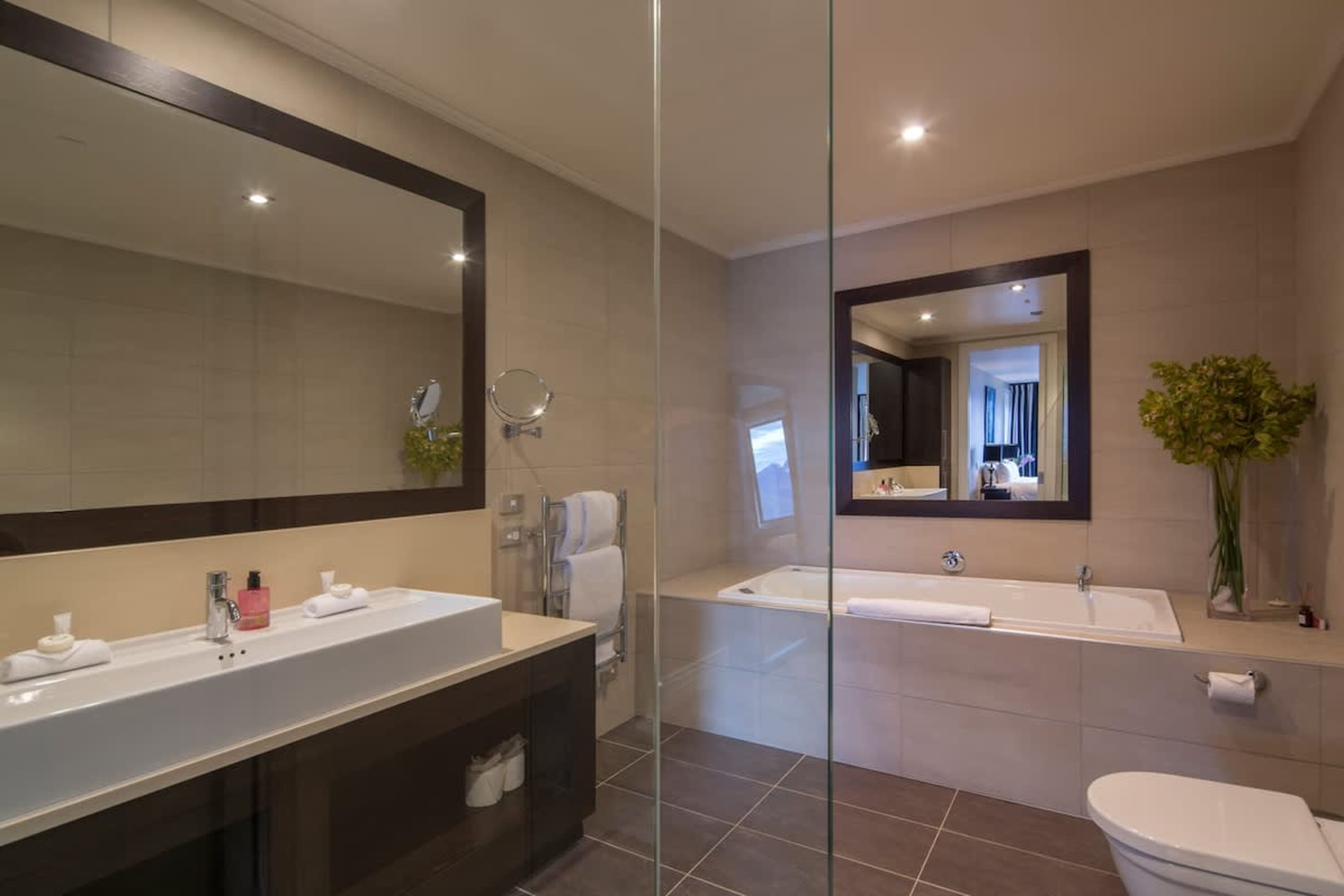 Luxurious Master Ensuite: Indulge in the spa bath or refresh in the spacious walk-in shower, complemented by premium Ashley & Co toiletries for a touch of elegance.
