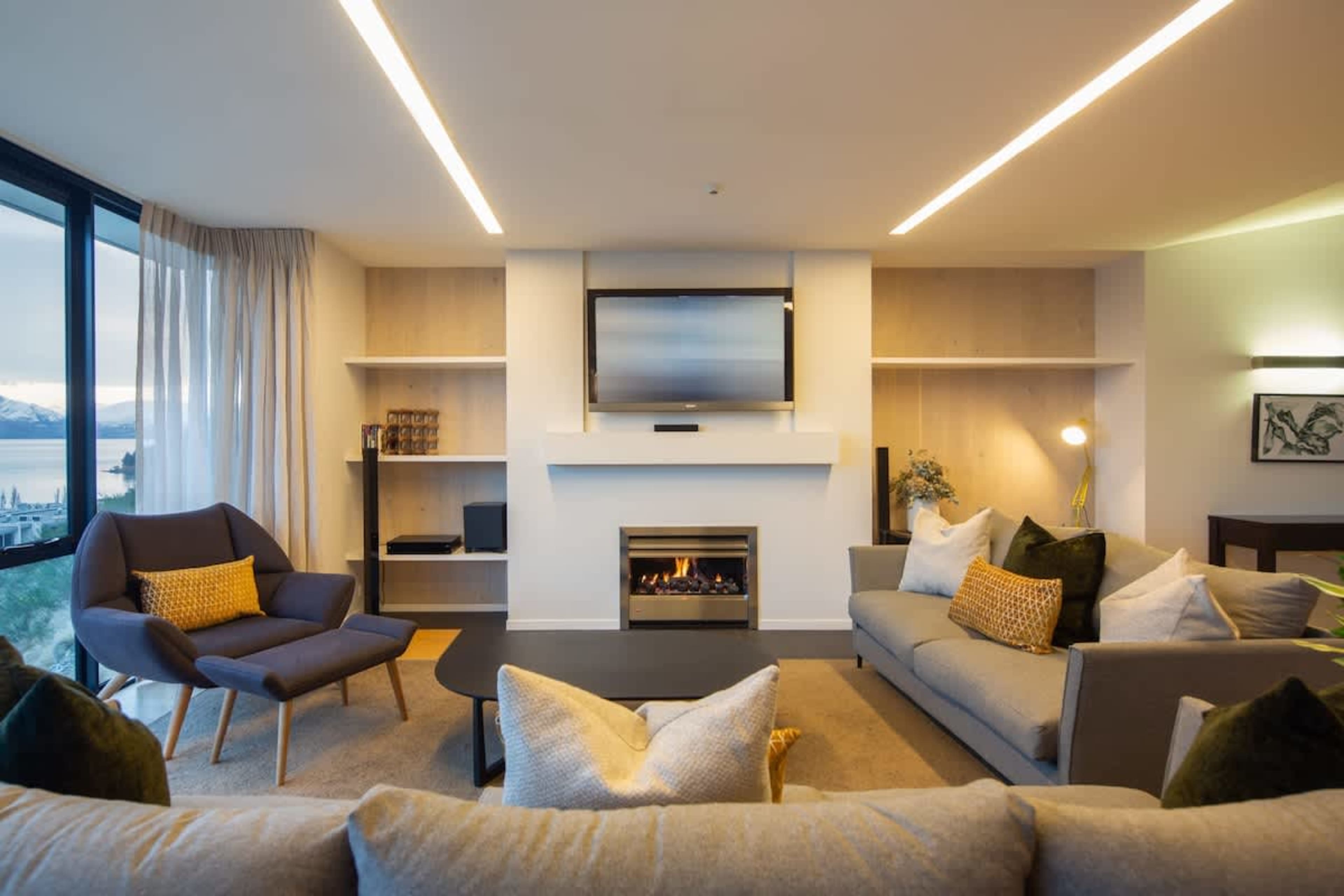 Experience a cozy and inviting atmosphere with a warm fireplace in our luxury Queenstown retreat. Perfect for unwinding after a day of adventure! ️