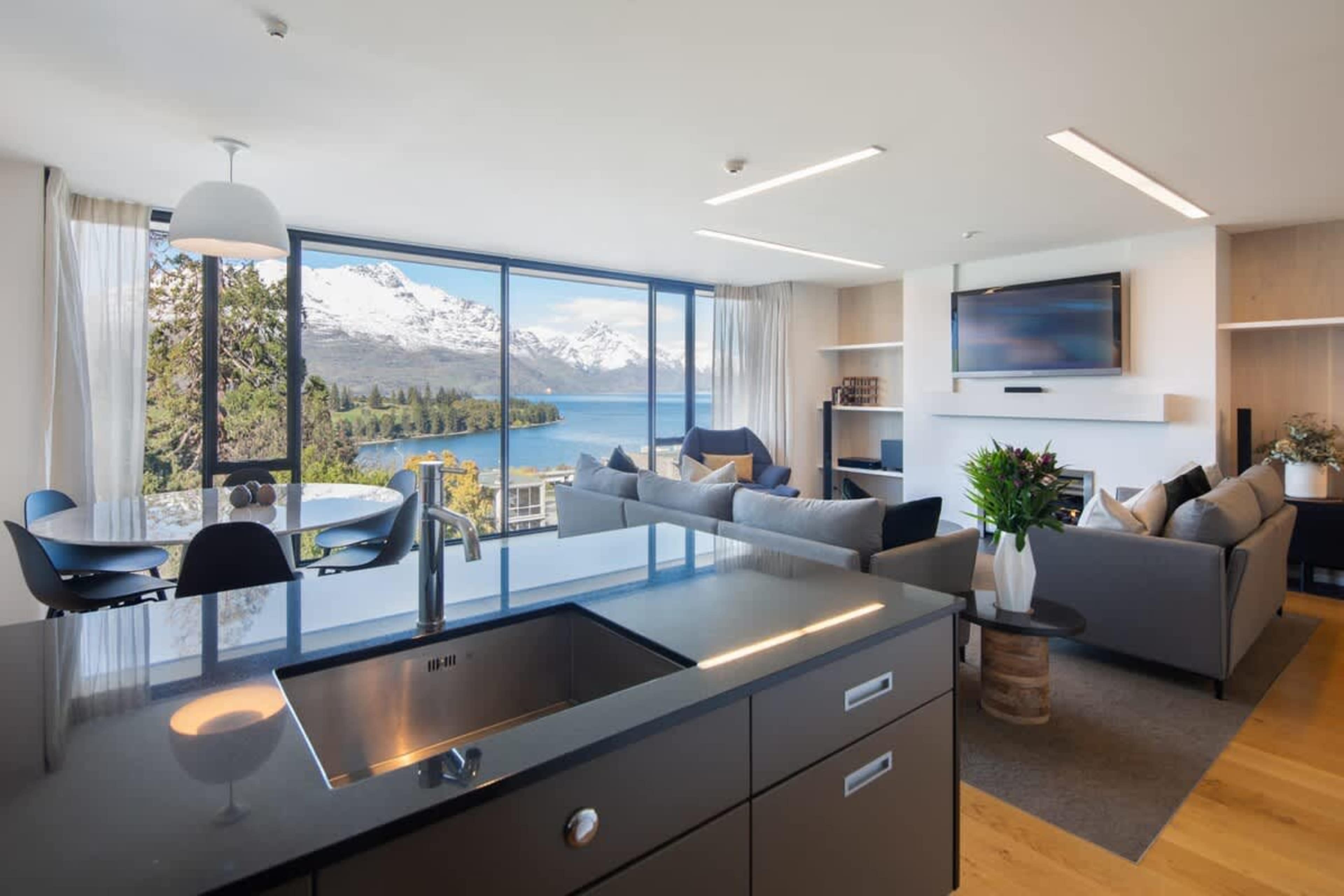 Admiring the stunning snow-covered mountains from the kitchen bench at our Queenstown villa