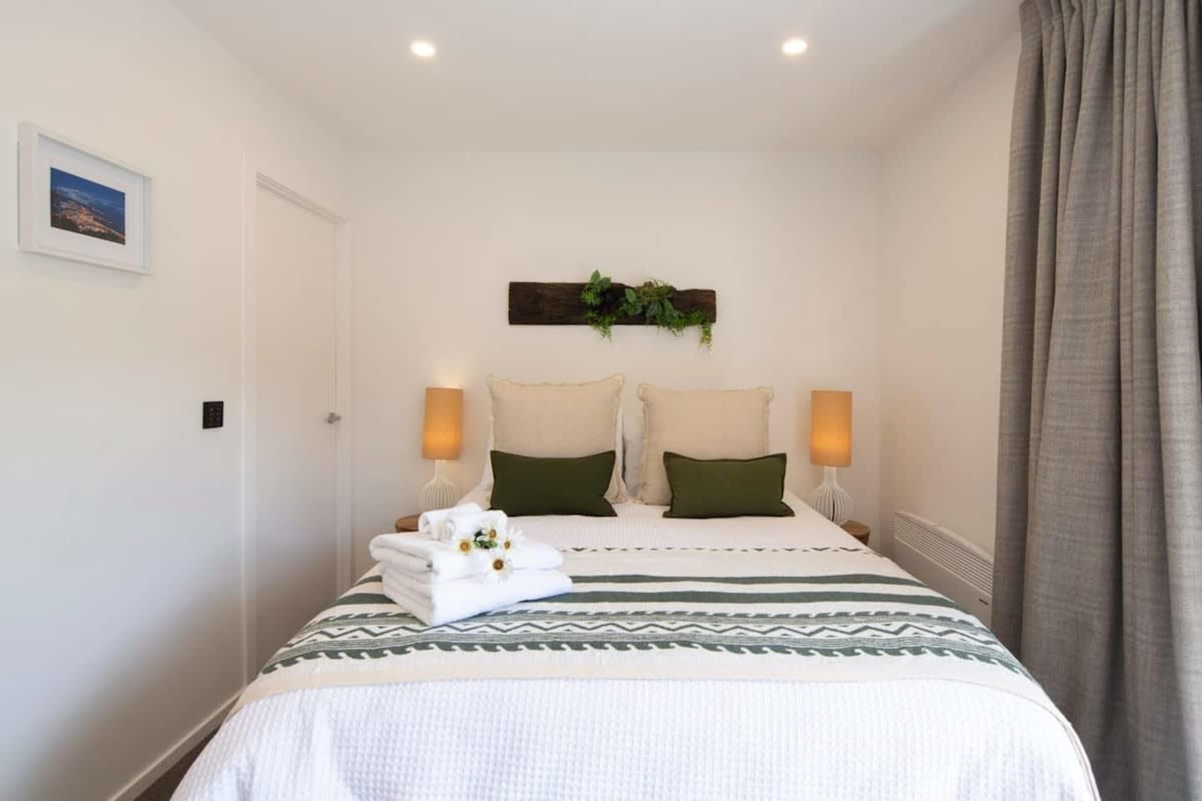Master Bedroom with Queen Bed, Ensuite, and Wardrobe
This cozy master bedroom features a queen bed, a private ensuite, and a spacious wardrobe. Perfect for relaxation, it offers comfort and convenience, making it an ideal retreat during your stay.