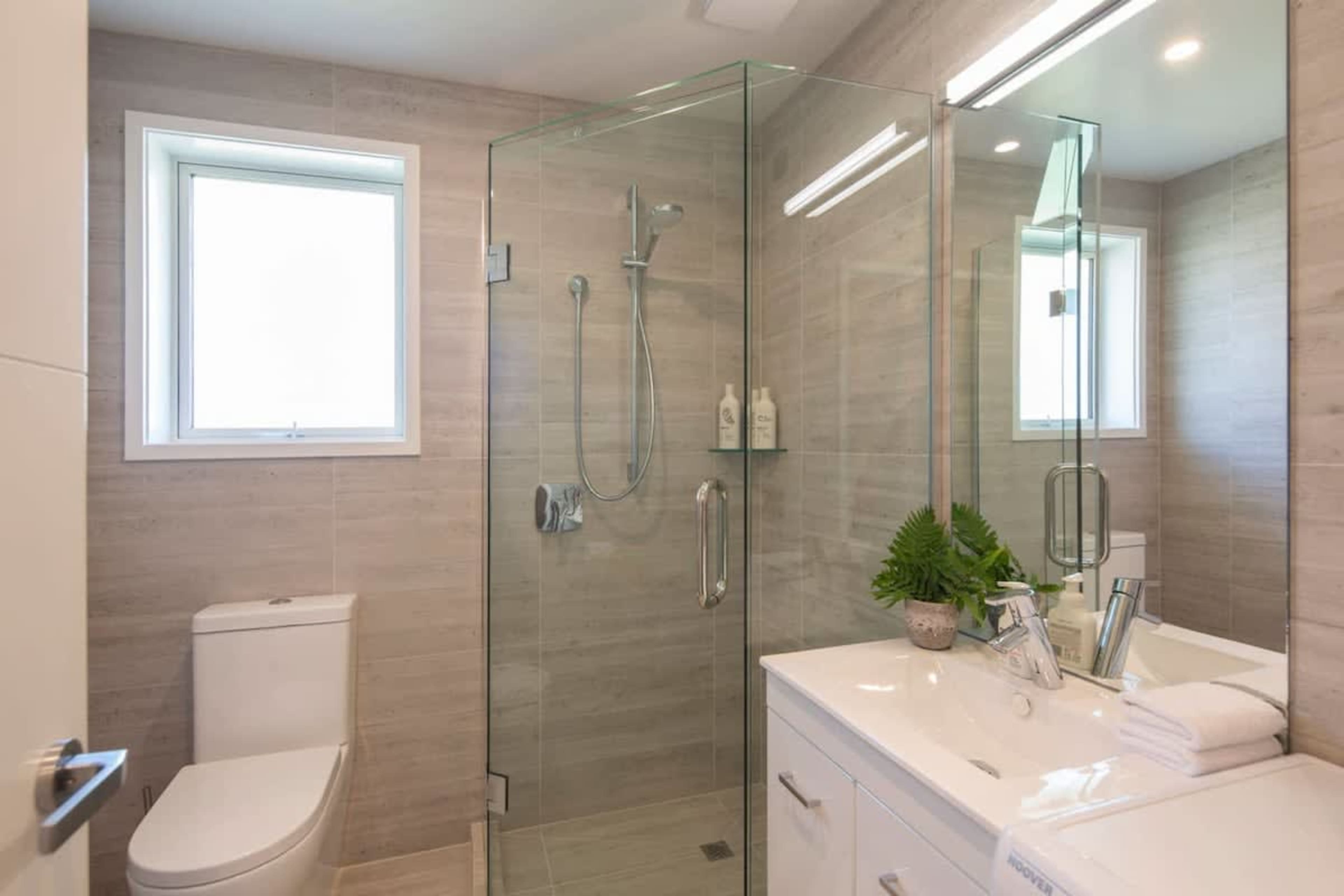 "Ensuite with Walk-in Shower 
This modern ensuite is attached to the master bedroom, featuring a walk-in shower and easy access to the wardrobe. With stylish finishes and thoughtful amenities, it offers a private, comfortable space for relaxation.