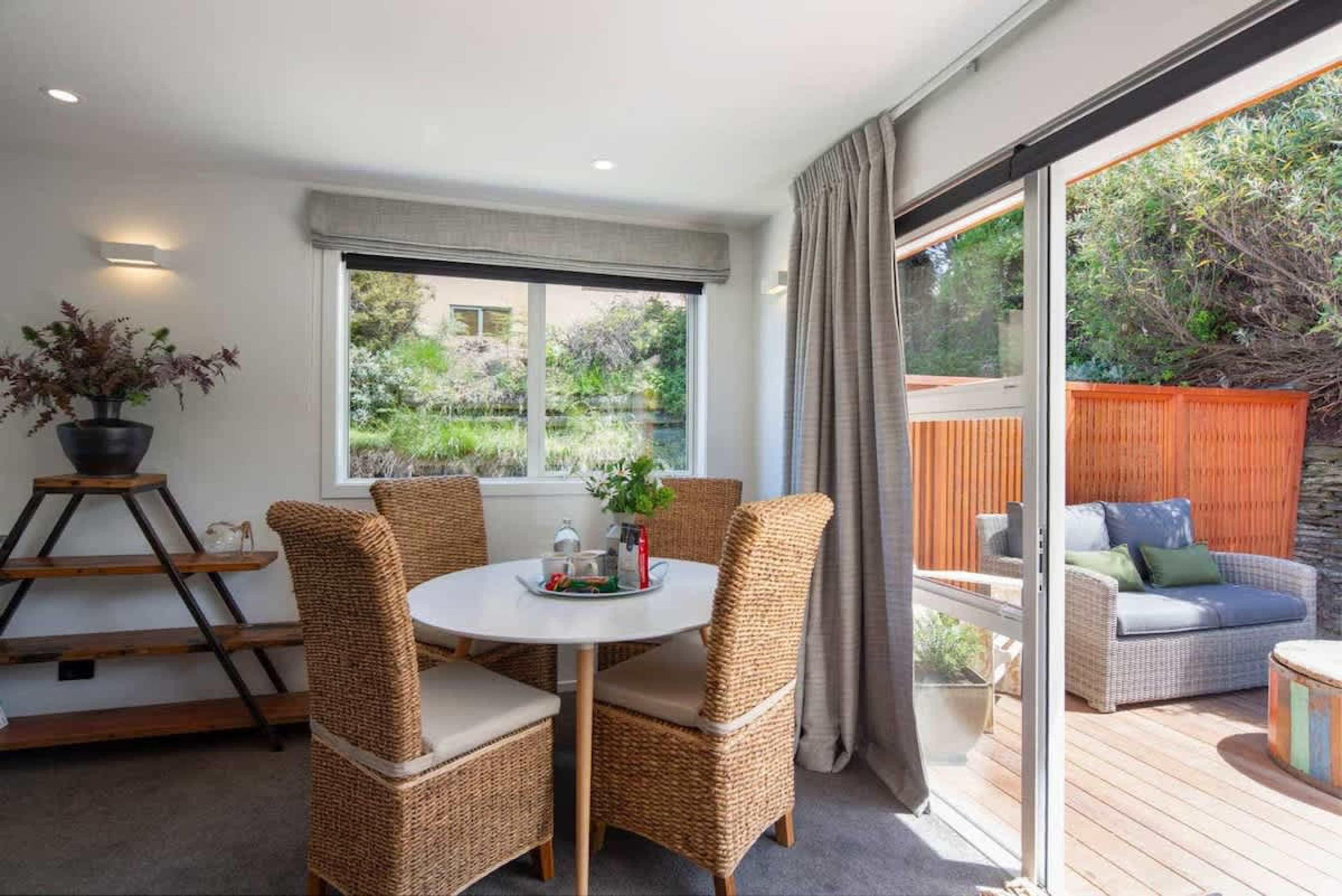 Dining Area with Patio Access
The spacious dining area offers a large table with comfortable seating and direct access to the sunny patio. It’s the perfect spot for enjoying meals while enjoying the fresh air and beautiful surroundings.