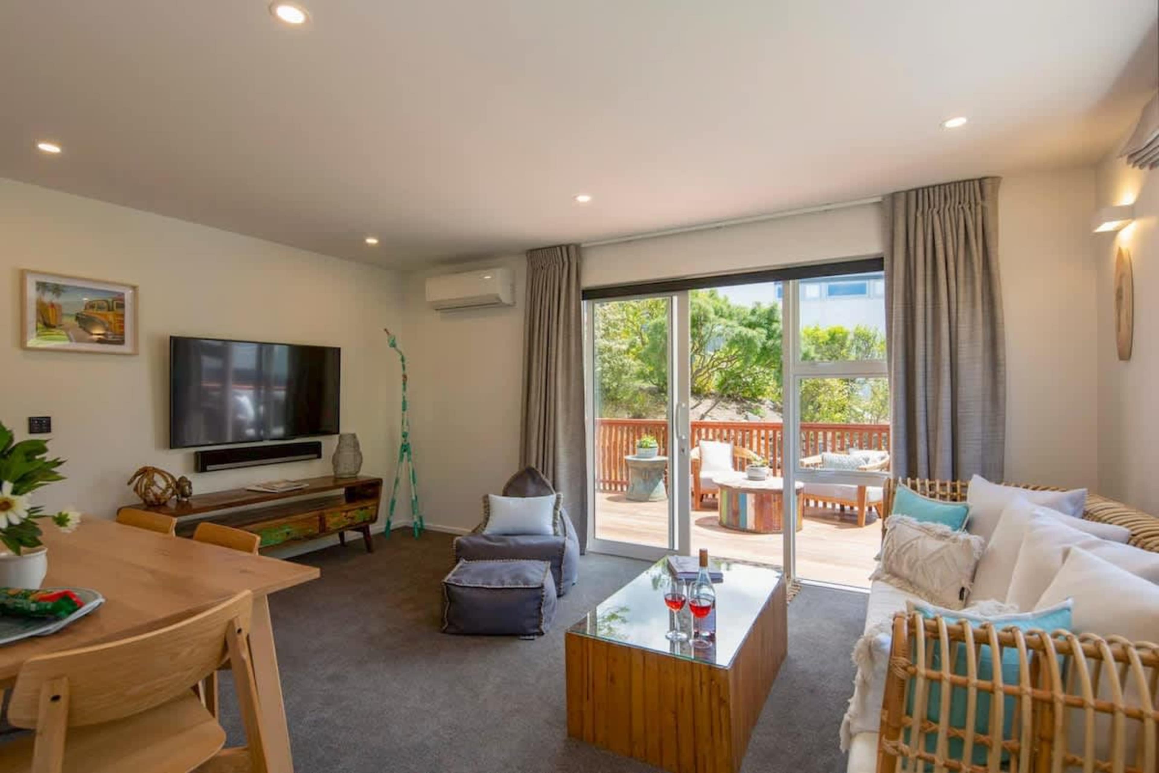 Living Room with Smart AV and Patio Access
Relax in the spacious living room with a smart TV, Netflix, and Sonos Playbar for great entertainment. With direct patio access, enjoy seamless indoor-outdoor living in this comfortable, stylish space.