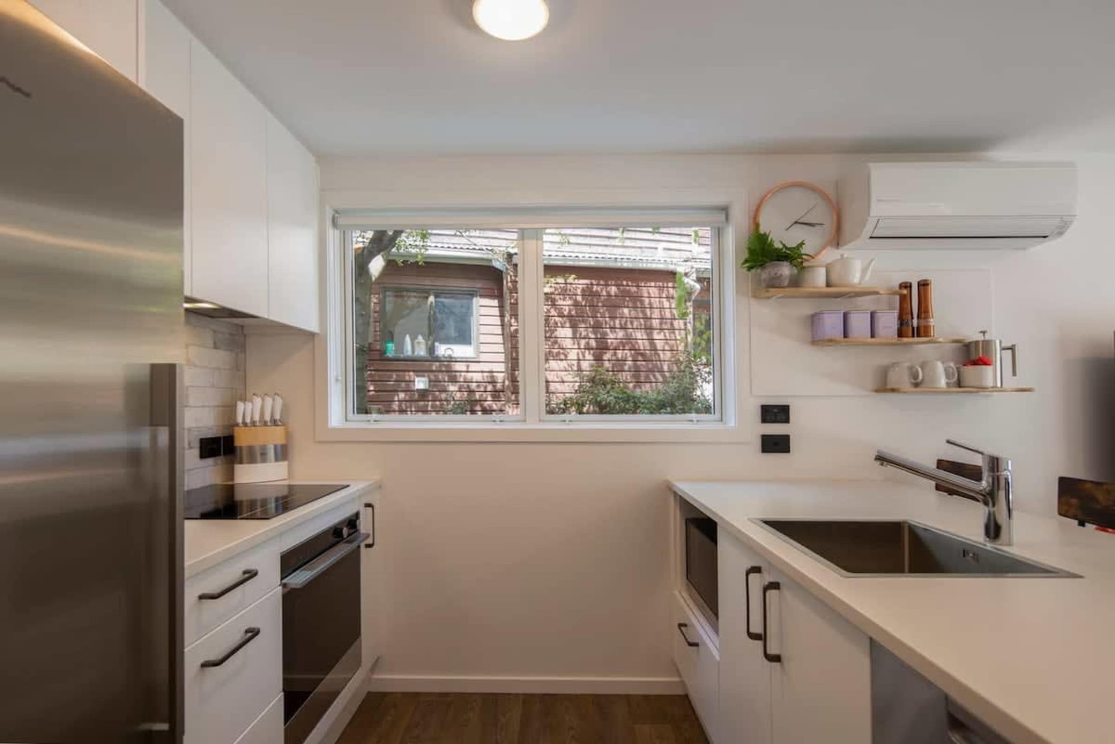 This well-equipped kitchen features modern appliances, plenty of counter space, and all the essentials needed to prepare meals. Whether you're cooking a gourmet dinner or a quick snack, it’s designed for convenience and style.