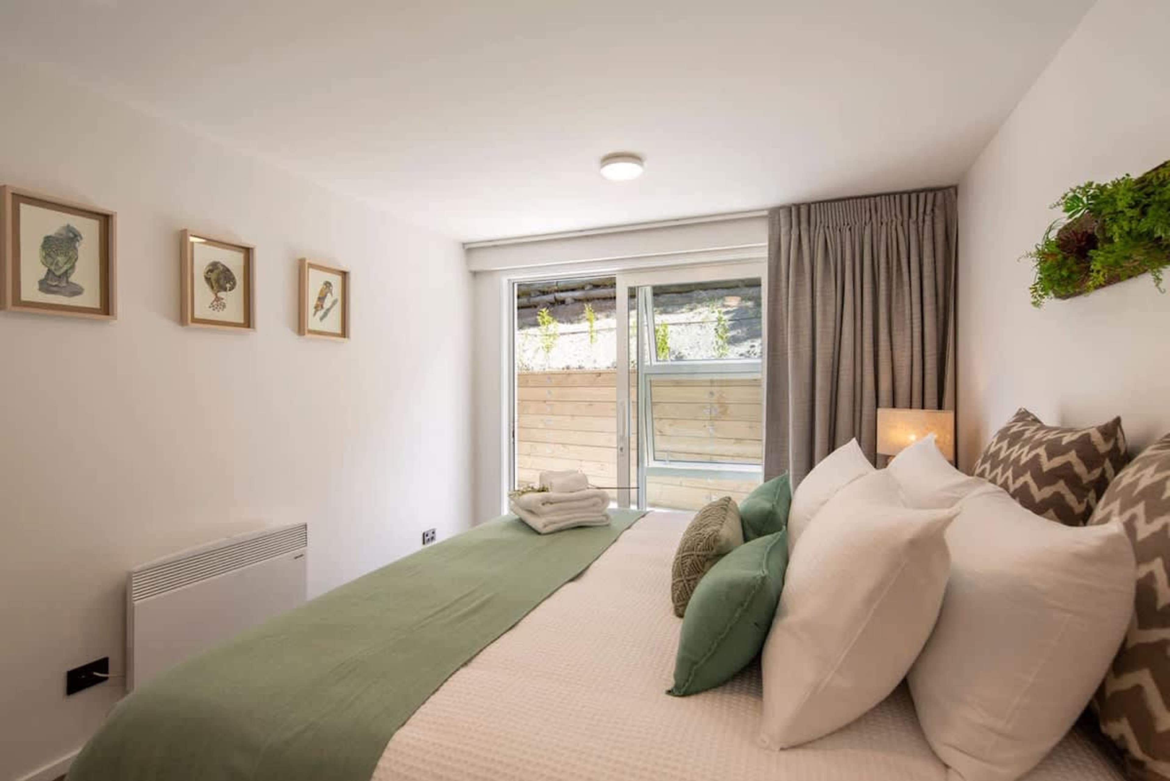 "Master Bedroom with Ensuite, Wardrobe, and Patio Access"
This spacious master bedroom features a king-sized bed, a private ensuite, and wardrobe. Enjoy direct access to the sunny patio, offering a serene space to unwind and take in the surroundings.