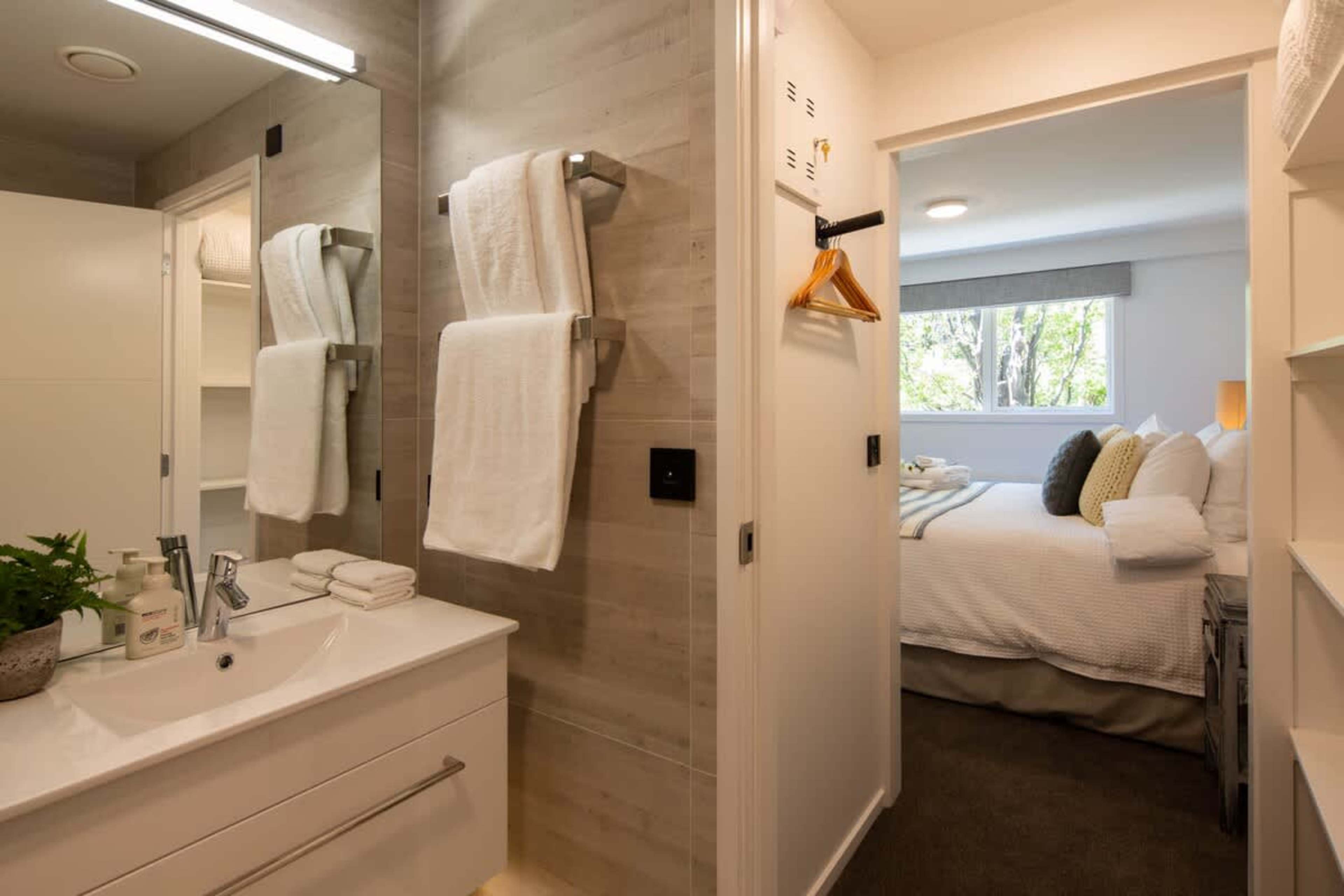 Second Ensuite with Heated Floors
This stylish second ensuite features a walk-in shower, heated floors for extra comfort, and Ashley & Co. toiletries. Designed for relaxation, it provides the perfect space to refresh after a day of exploring.