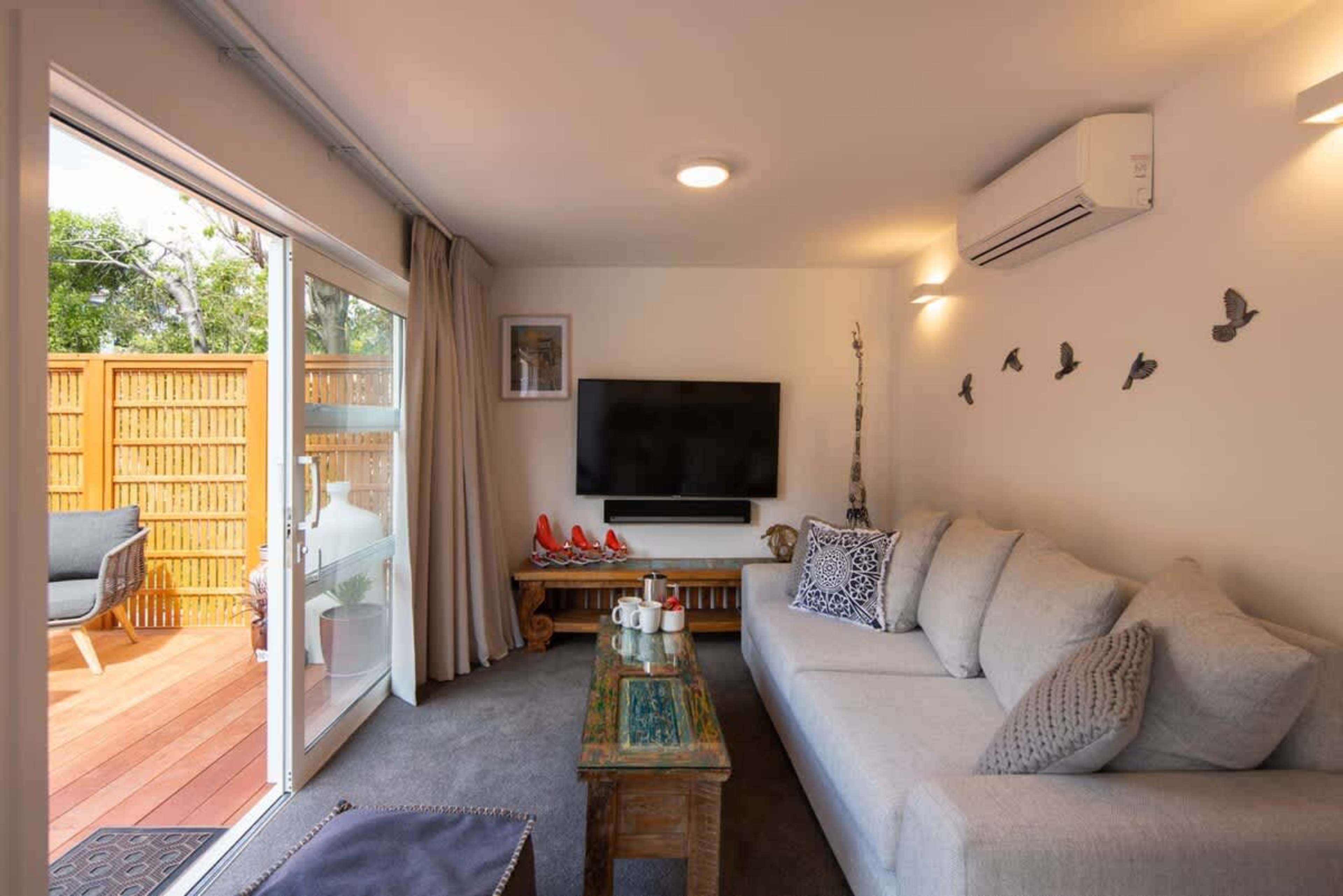  Modern Amenities"
This inviting living room features a smart TV, Sonos Playbar, and underfloor heating for ultimate comfort. With a heat pump and stylish furnishings, it's the ideal space to relax and enjoy entertainment after a day out.