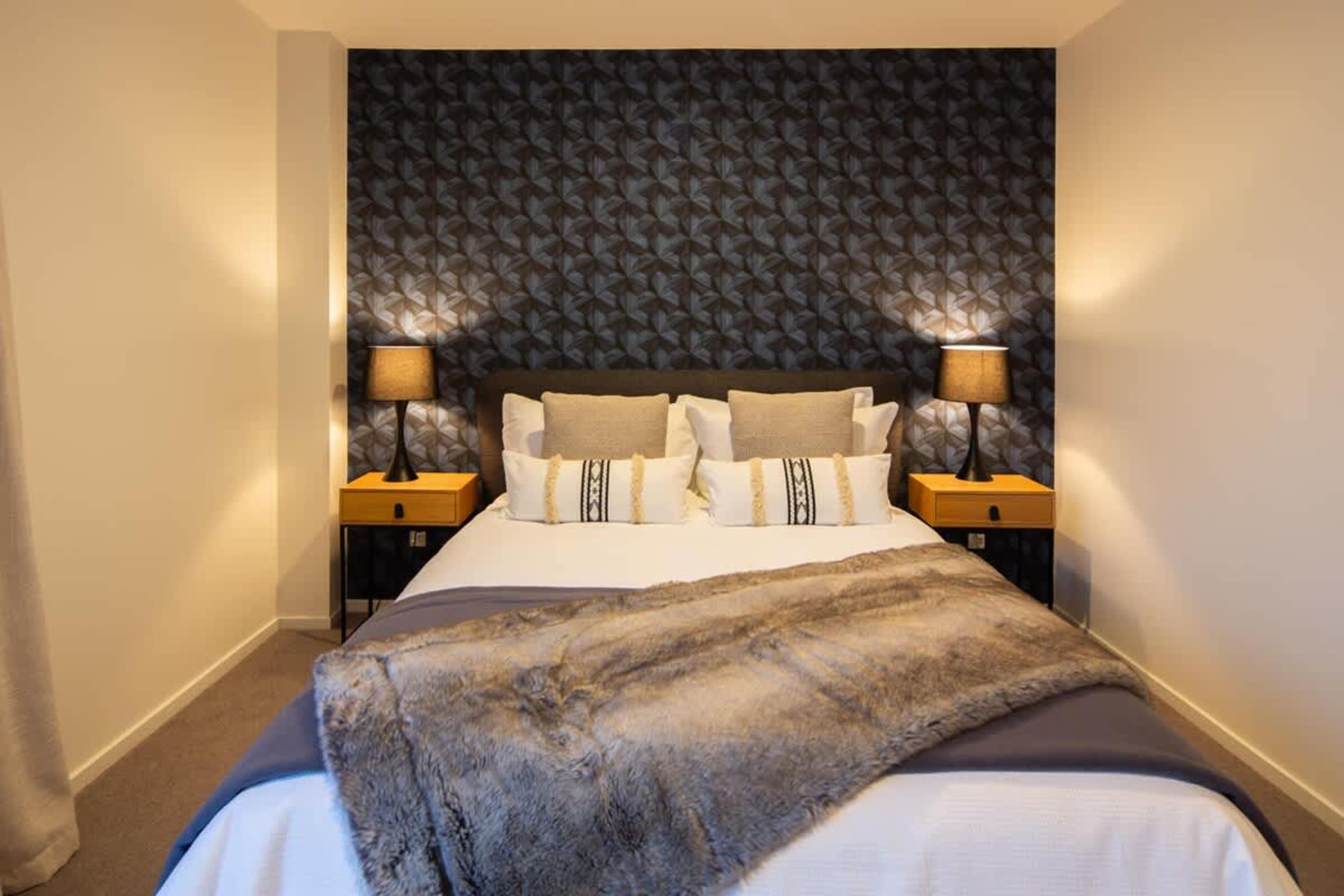Relaxing Bedroom with Scenic Views
Enjoy a peaceful stay in this third bedroom with stunning views of the lake and mountains. Designed for comfort, it offers a tranquil setting with stylish furnishings and plenty of space to unwind.