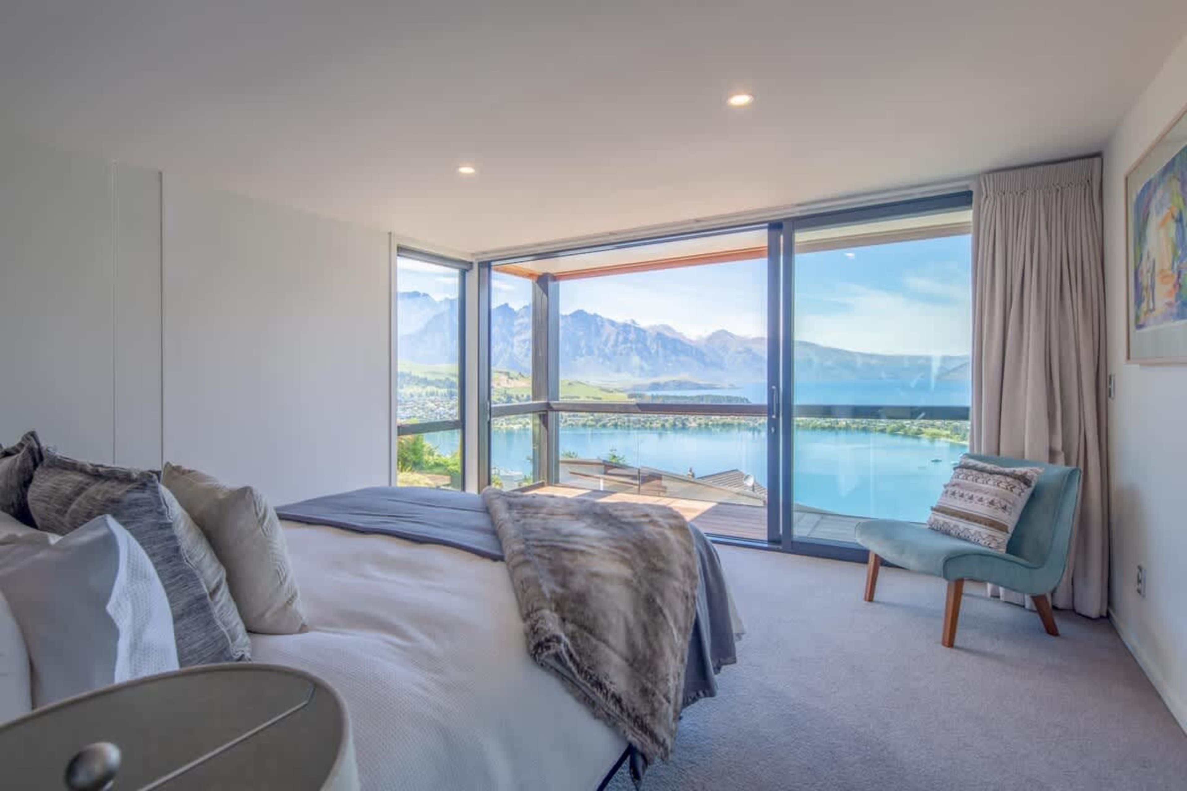 Serene Master Bedroom with Ensuite
Relax in the master bedroom, complete with a king-sized bed, walk-in wardrobe, and an ensuite with a bathtub and walk-in shower. With beautiful views of the lake and mountains, it offers comfort and luxury.