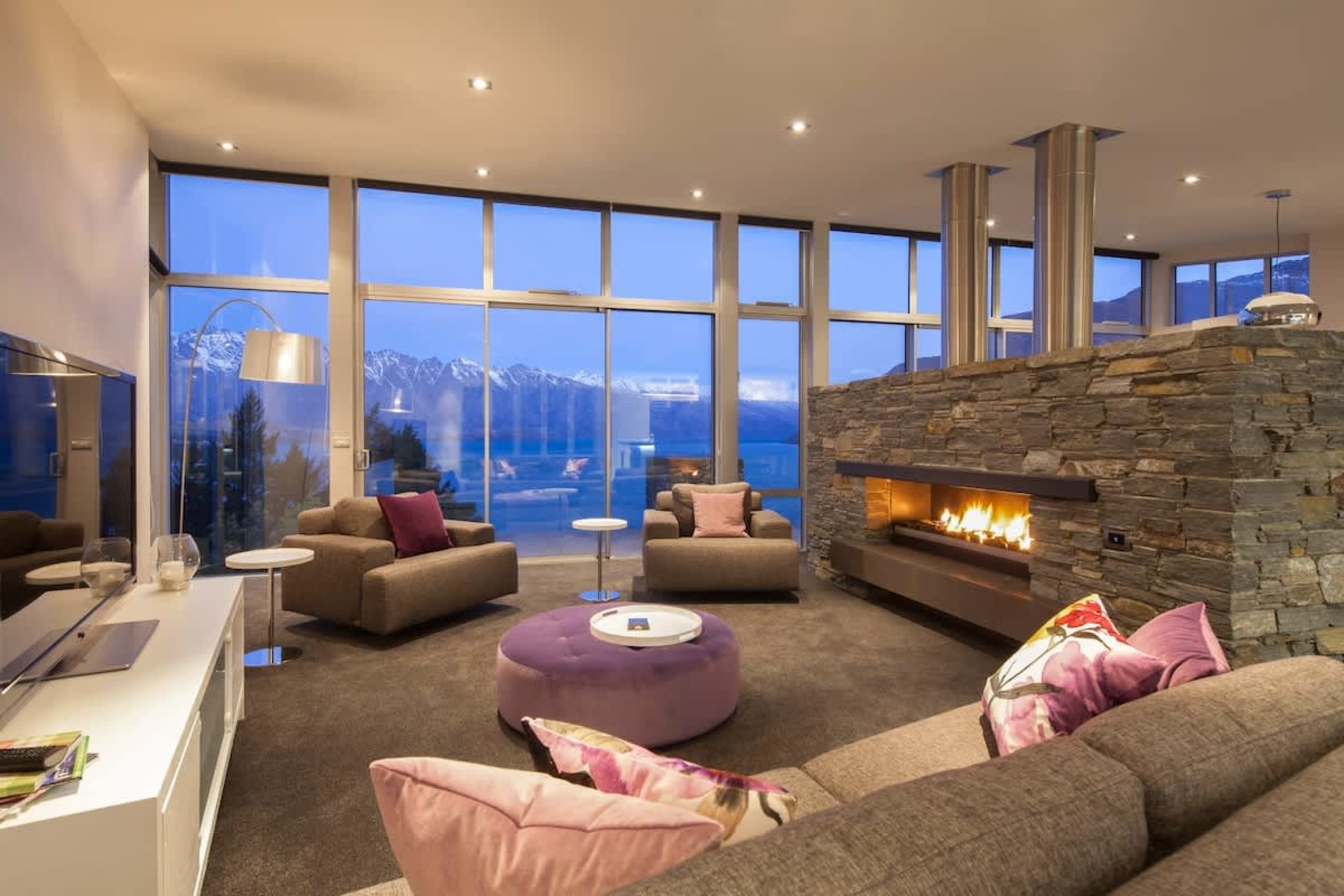 Cozy and warm living area with a large TV at our 5-star accommodation in Queenstown