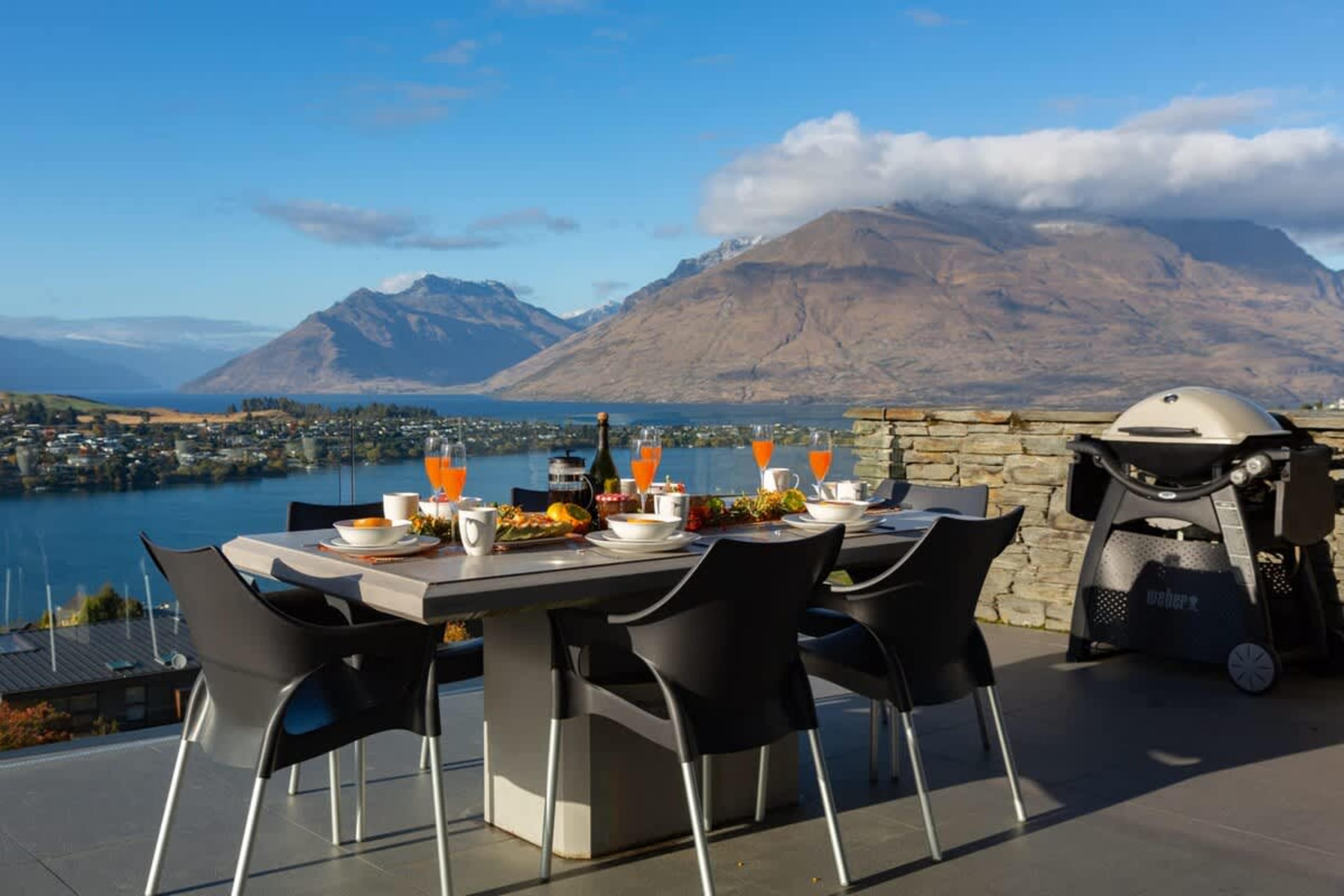 Sun-Soaked Balcony with BBQ and Outdoor Seating – Enjoy ultimate relaxation on this sun-drenched balcony, complete with a BBQ and cozy seating, offering breathtaking views of the lake and mountains.