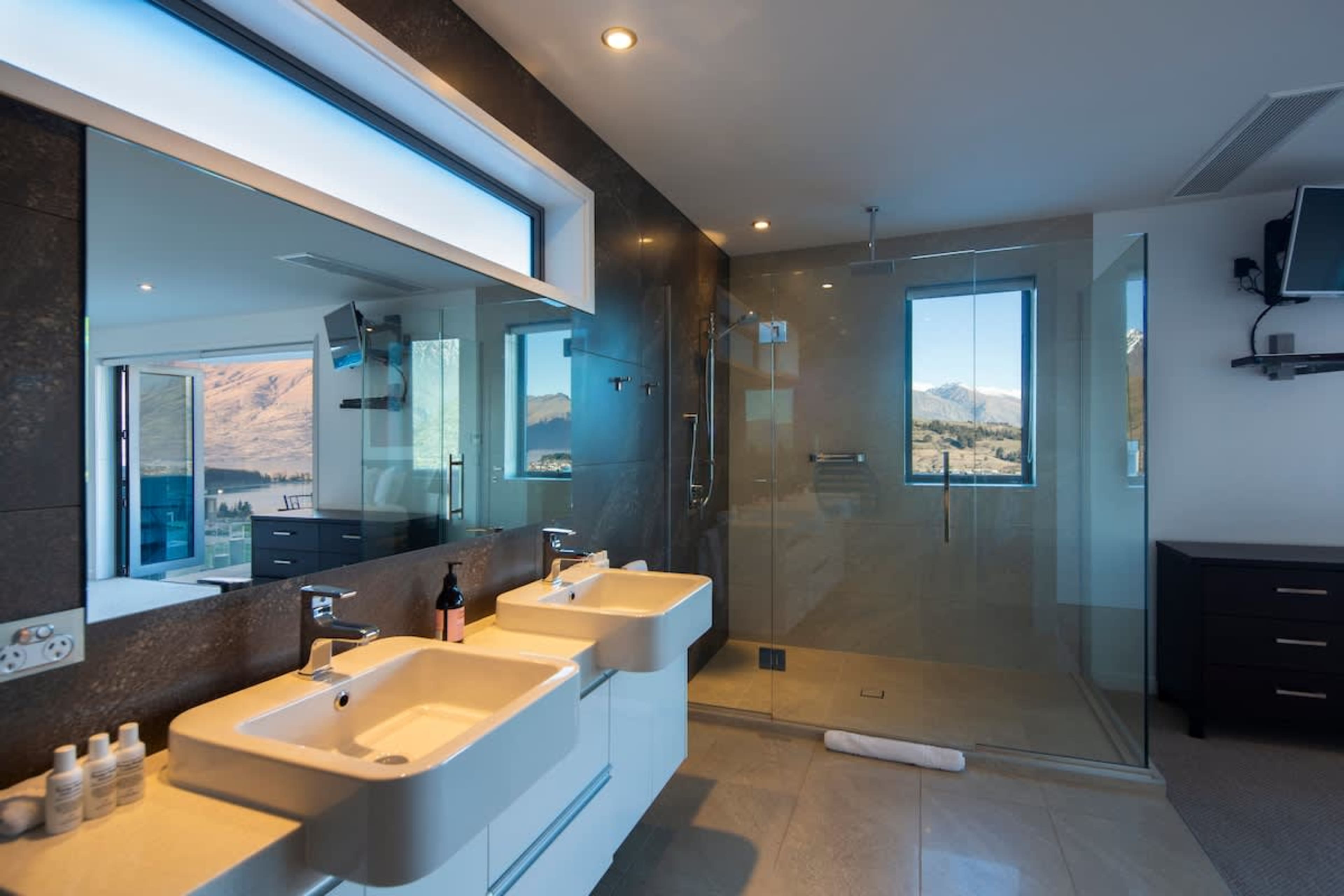 Luxury and Functionality Combined
Indulge in the spacious bathroom featuring sleek his-and-her sinks, a modern walk-in shower, and the comfort of heated floors. Thoughtfully designed for relaxation and convenience.