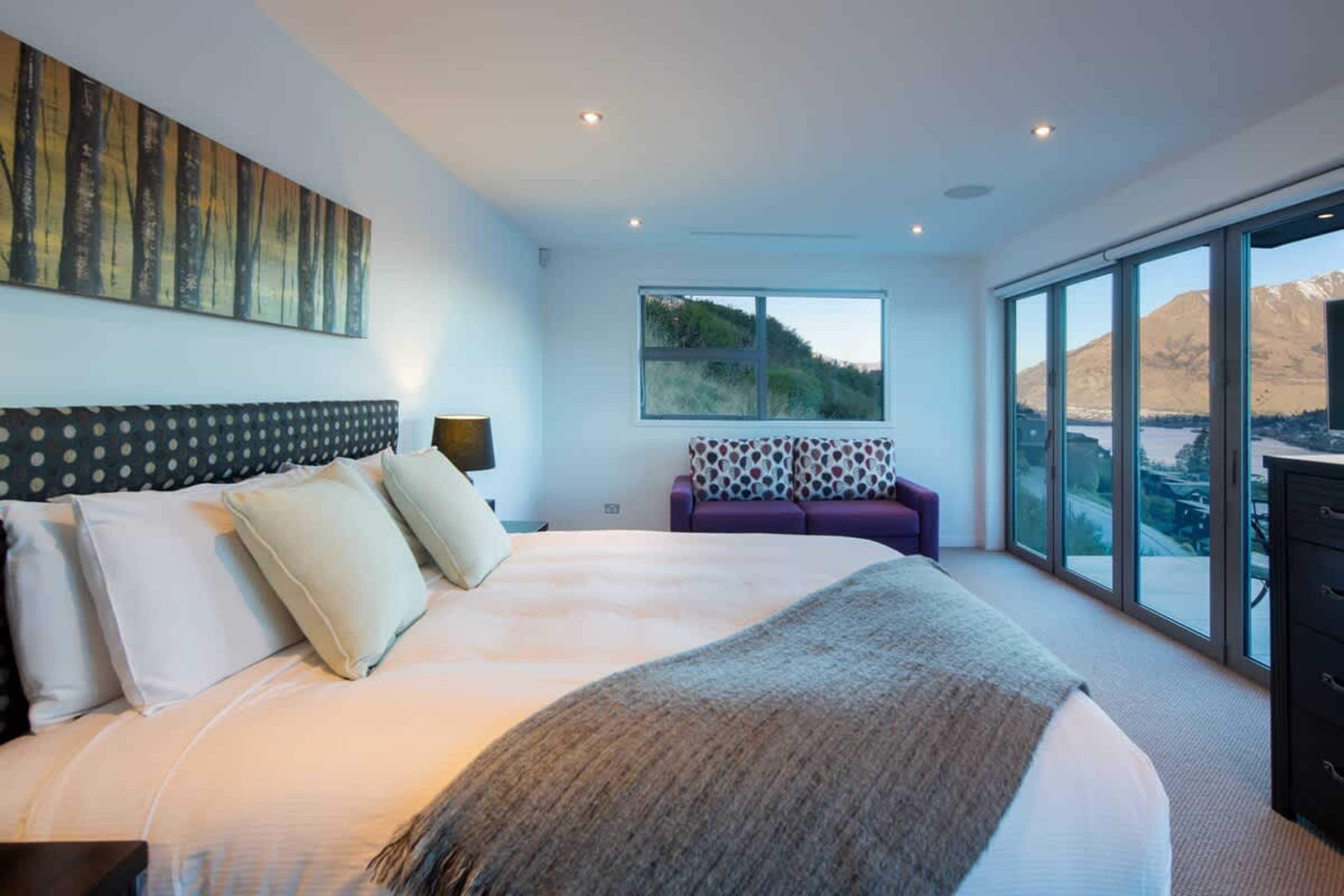 Serene Master Bedroom Oasis – Wake up to breathtaking lake and mountain views from this elegantly appointed master suite, featuring a private balcony perfect for quiet moments of relaxation.