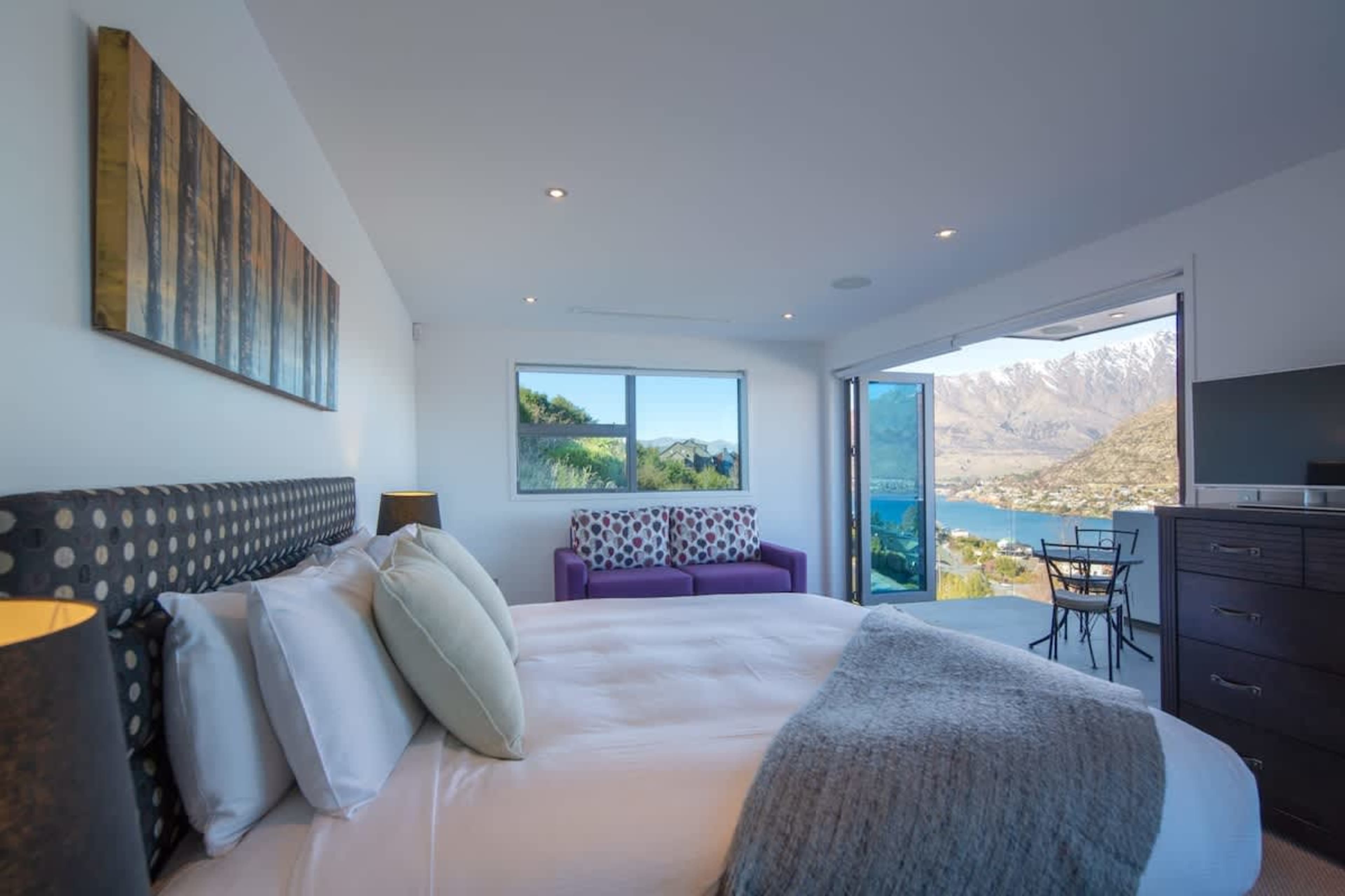 Luxurious Master Suite with Private Balcony – Escape to the spacious master bedroom, complete with plush bedding and exclusive access to a private balcony offering breathtaking lake and mountain views.
