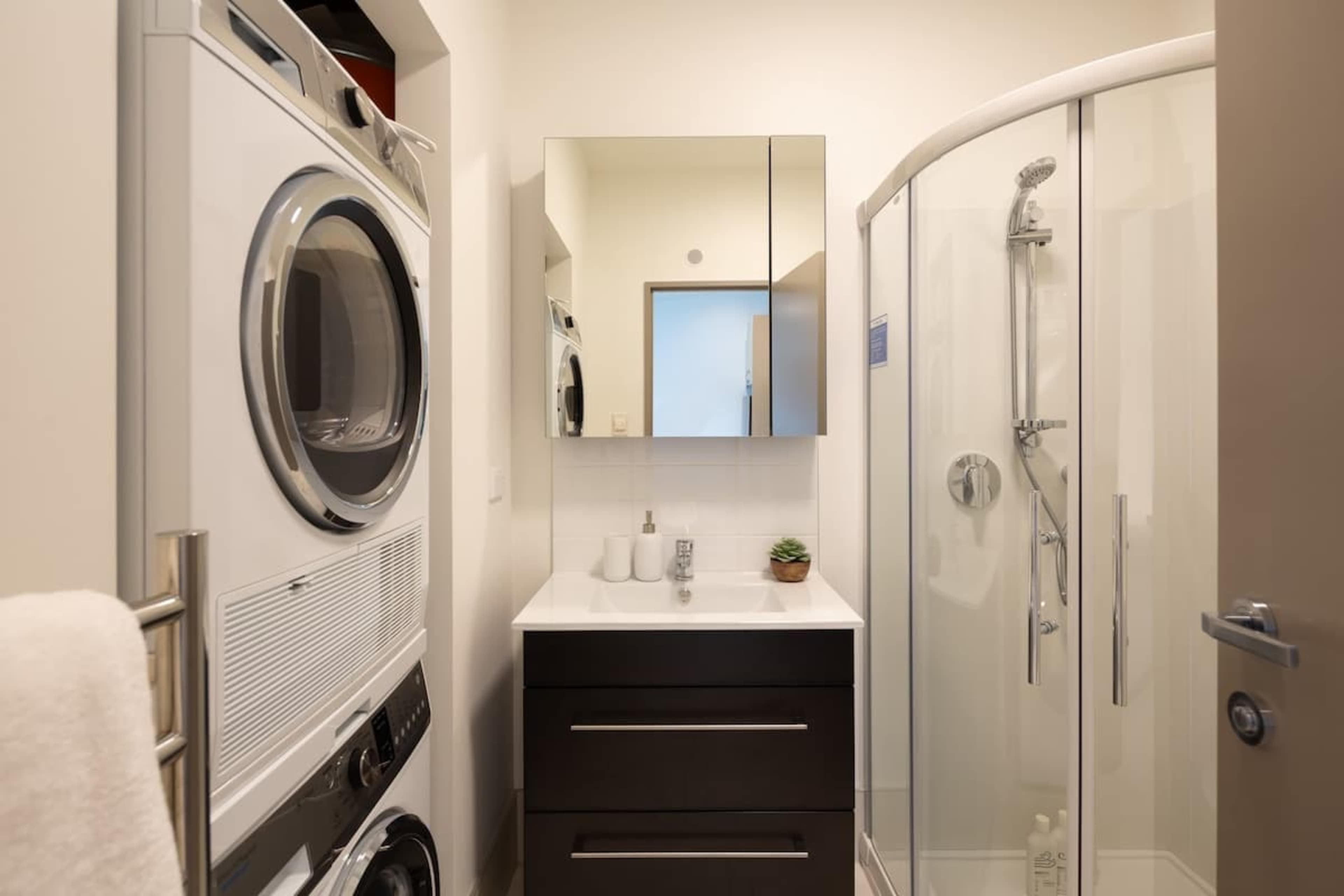 Stylish Bathroom with Heated Floors – This modern bathroom features under-tile heating for extra comfort, premium Ashley & Co toiletries, and sleek fixtures for a luxurious experience.