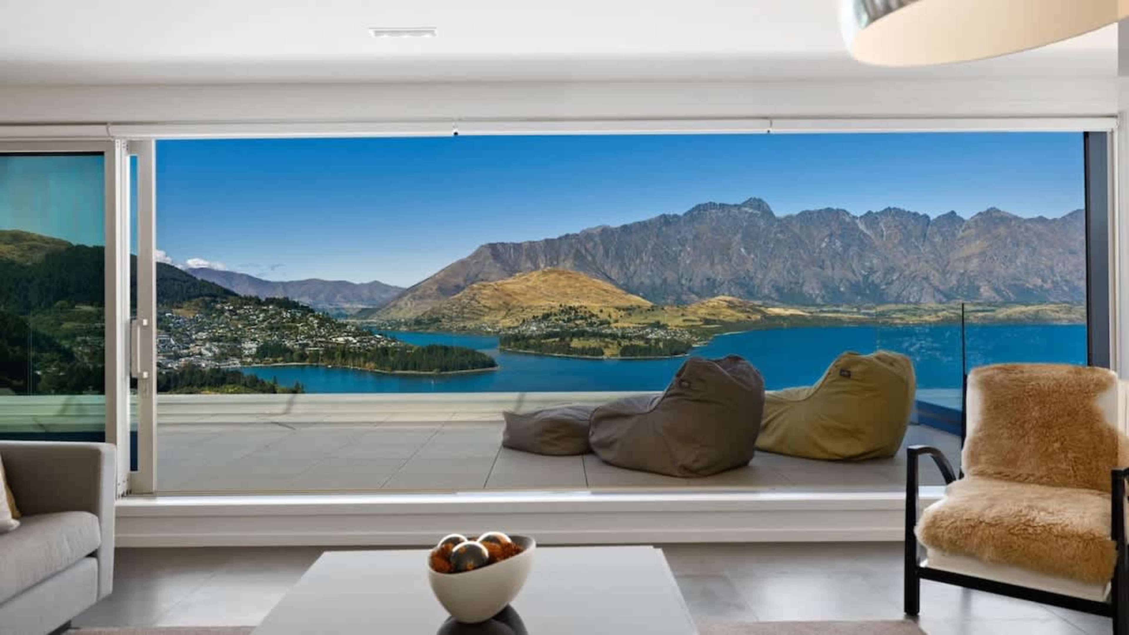 Sophisticated Living Space
Relax in the elegant living room, boasting bespoke furniture, a stunning fireplace, and floor-to-ceiling windows that showcase breathtaking views of Lake Wakatipu and the Remarkables.