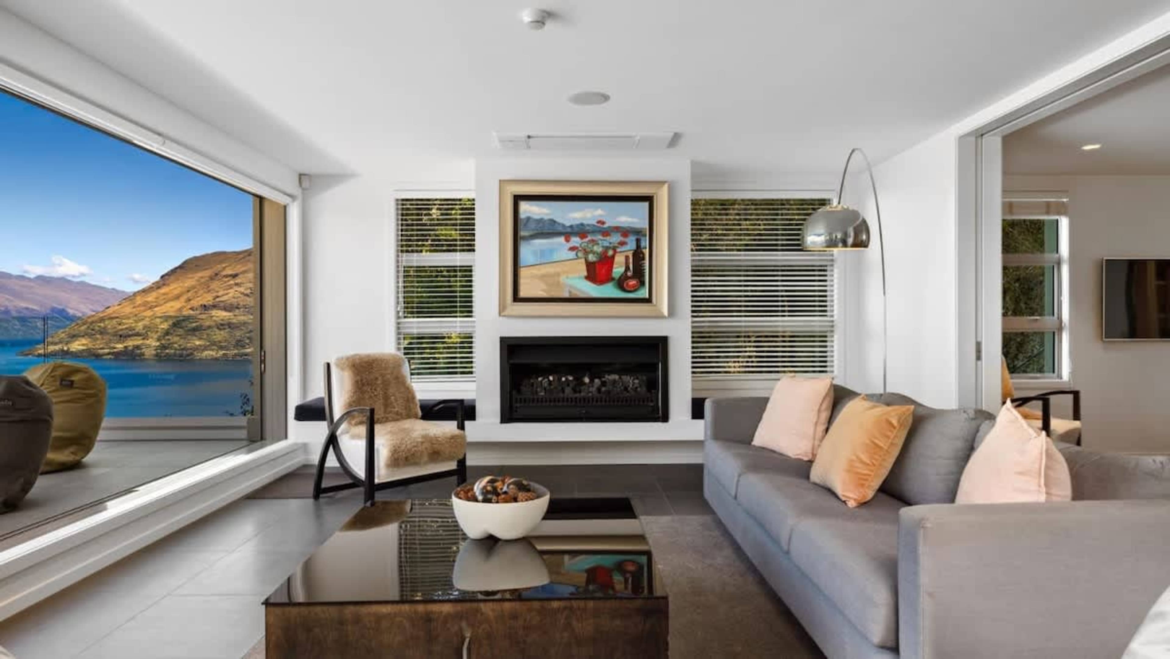 Luxurious Comfort
Relax in style in the penthouse living room, complete with exquisite décor, a cozy fireplace, and unobstructed views of Queenstown’s majestic mountains and lake.