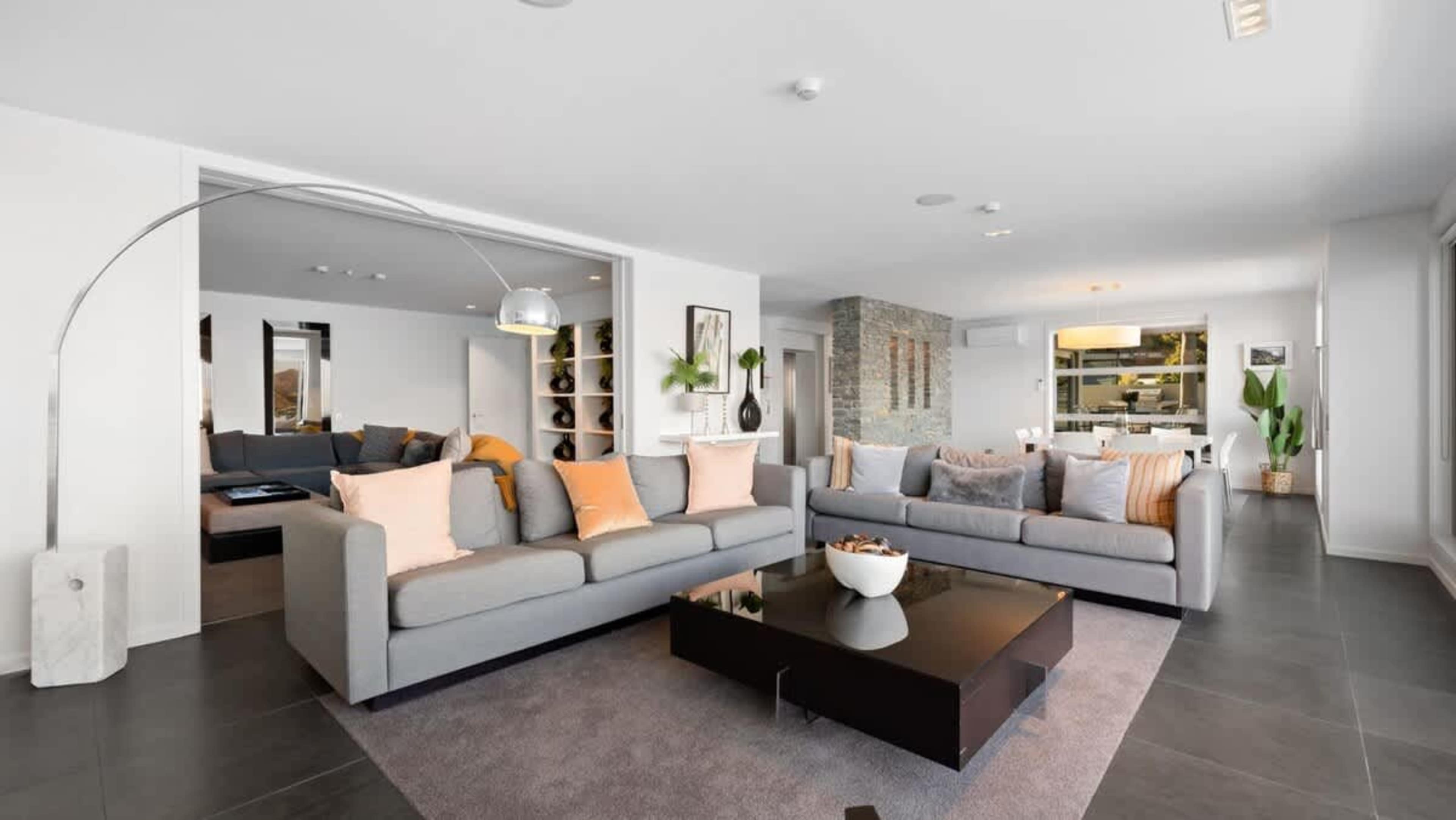 Open-Plan Luxury
Enjoy the spacious, open-plan living room with designer furnishings, an indoor fireplace, and large windows framing the stunning Queenstown scenery.