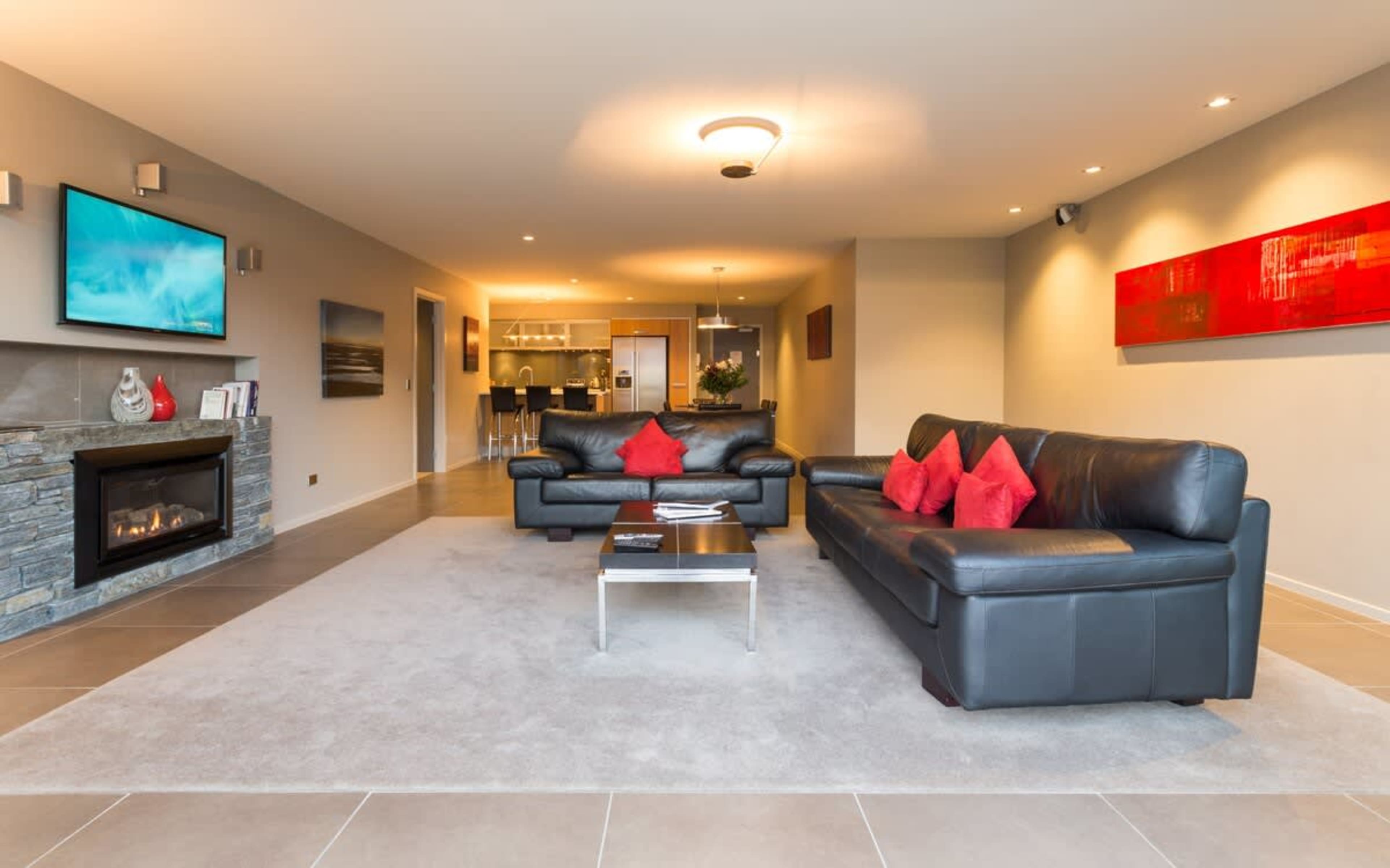 Comfortable lounge with fireplace and TV in our Queenstown 2 bedroom accommodation