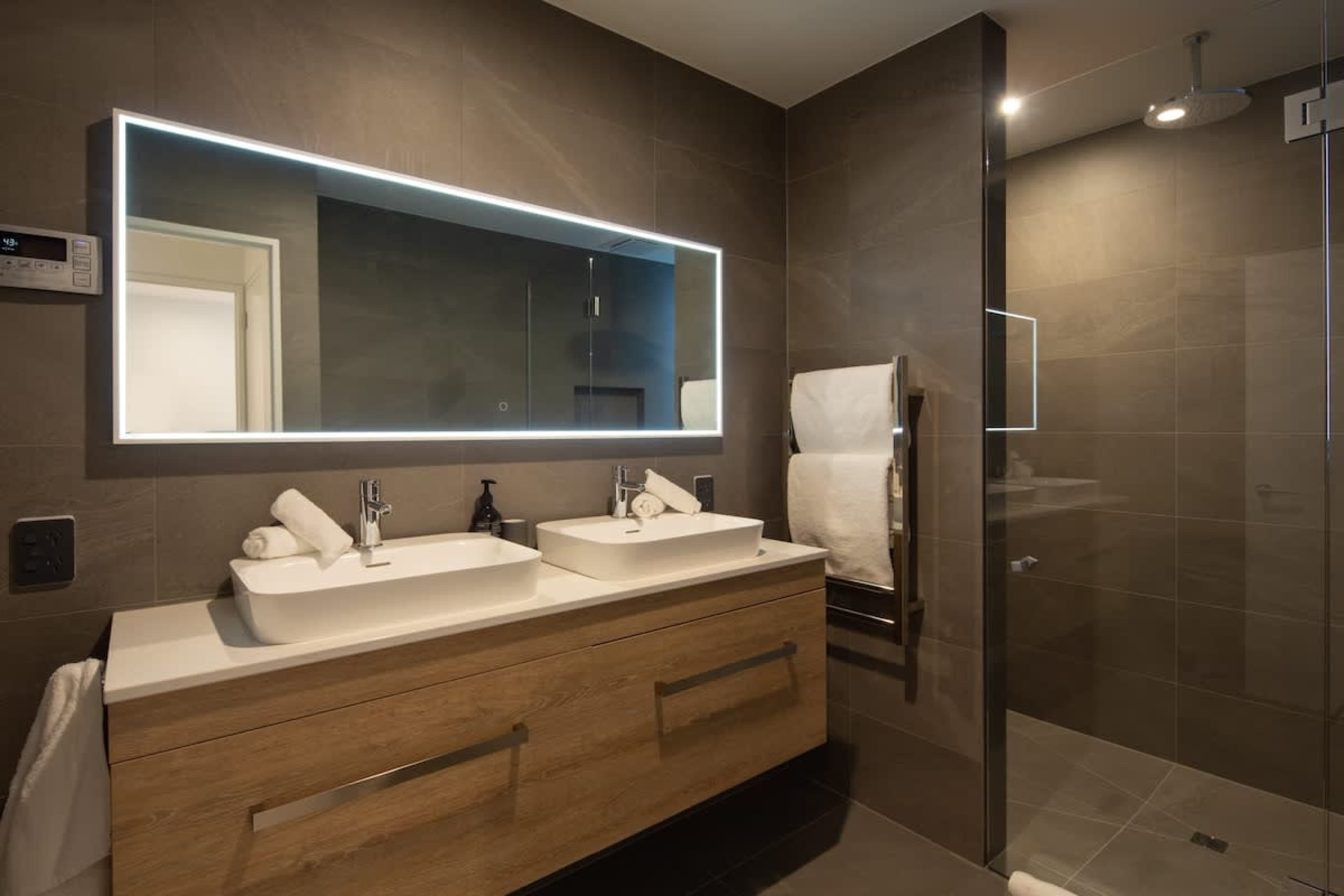 Contemporary Third Bathroom – This stylish bathroom includes a walk-in shower, elegant fixtures, and premium Ashley & Co toiletries, providing a comfortable and luxurious space for your stay.