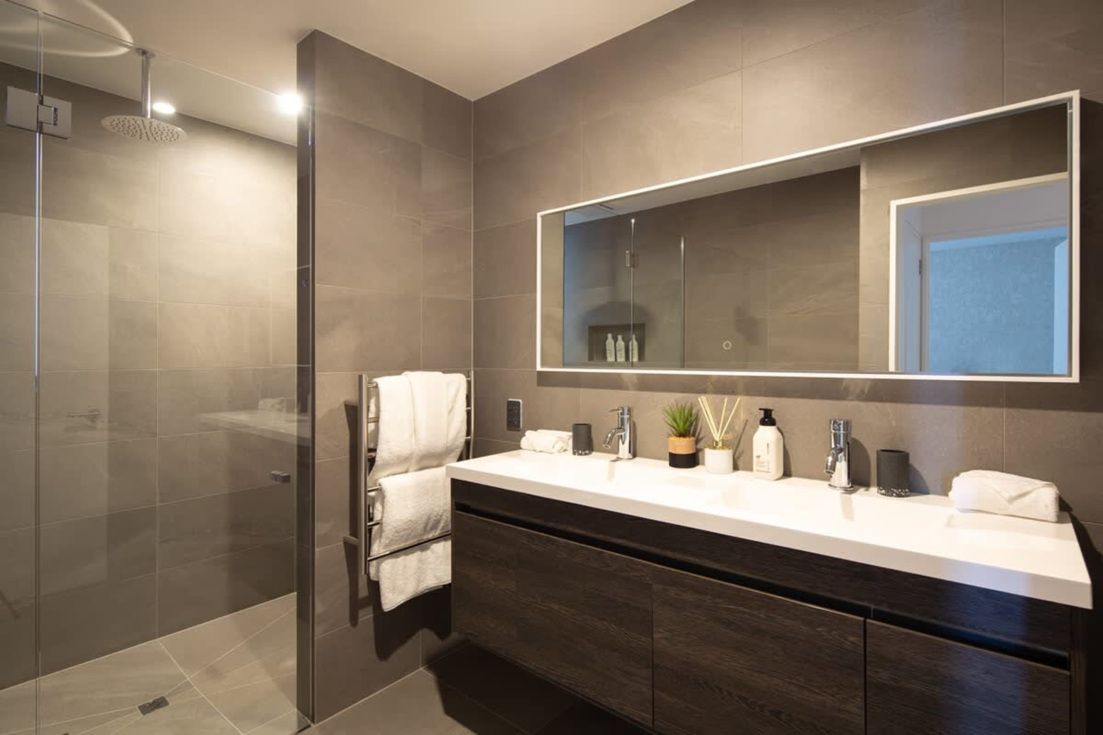 Contemporary Third Bathroom – Featuring a stylish design with a walk-in shower, elegant fixtures, and Ashley & Co toiletries, this bathroom provides both convenience and a touch of luxury.