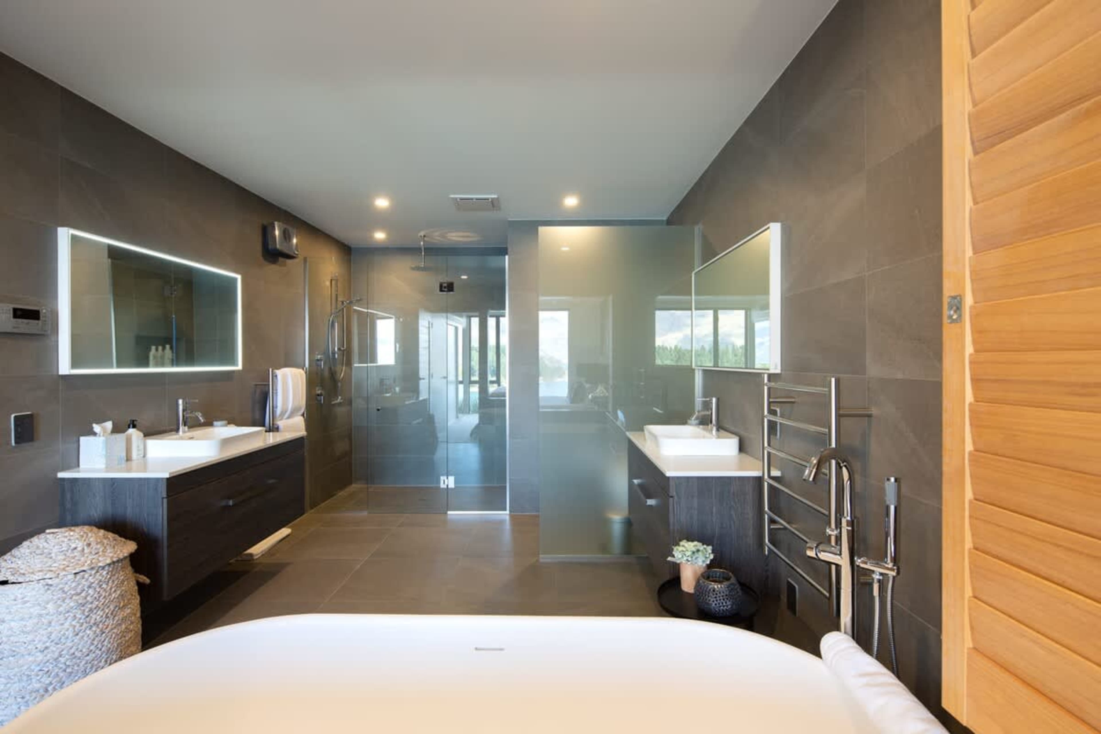 Opulent Master Ensuite with Spa Tub – Relax in the spa tub, enjoy the warmth of heated floors, and refresh with Ashley & Co toiletries, all in this beautifully designed master bathroom.