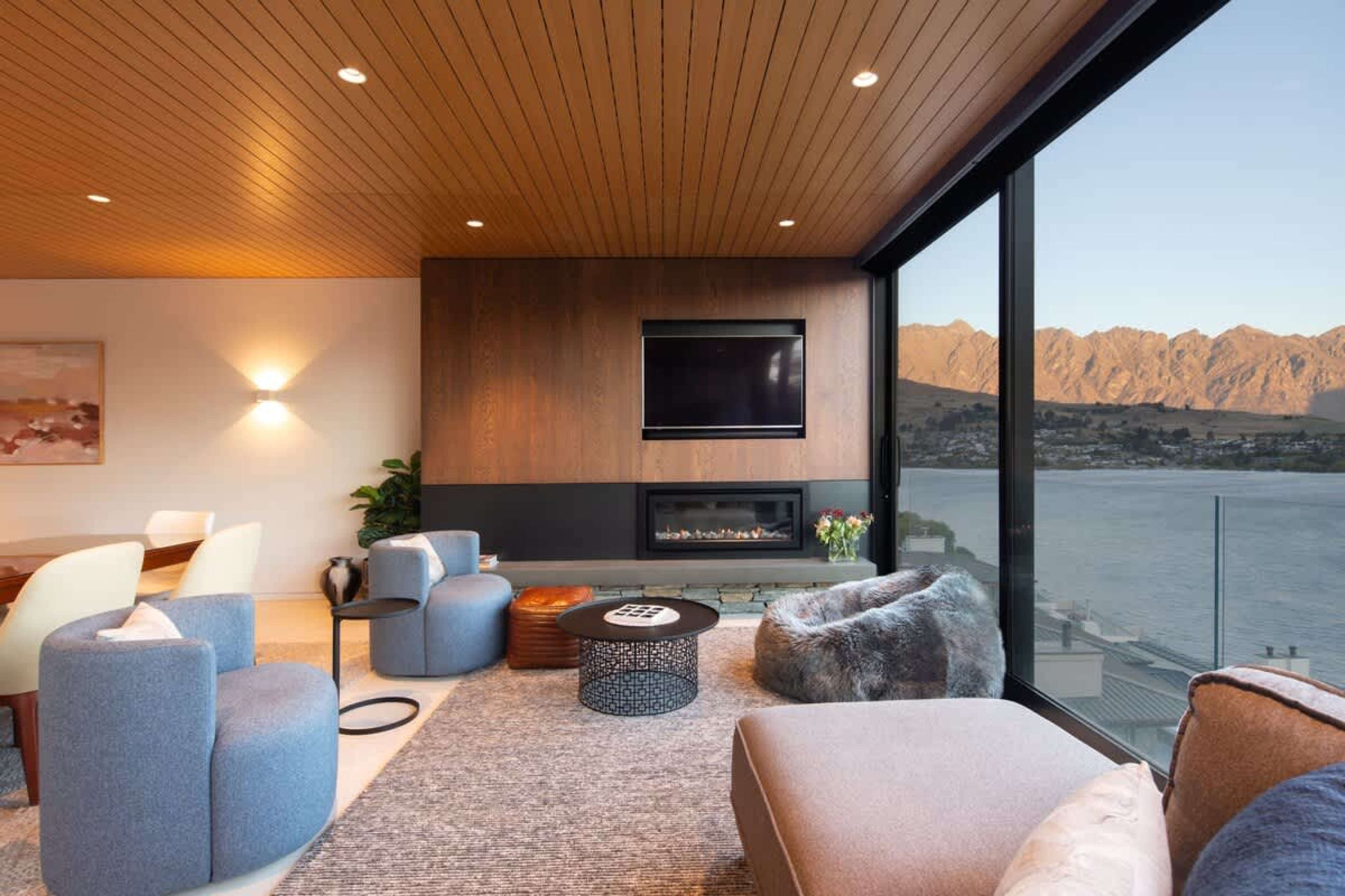 Luxury Living Room with Lakefront Access – Experience seamless indoor-outdoor living in this elegant space, featuring expansive windows that offer stunning views of Lake Wakatipu and direct access to the waterfront.
