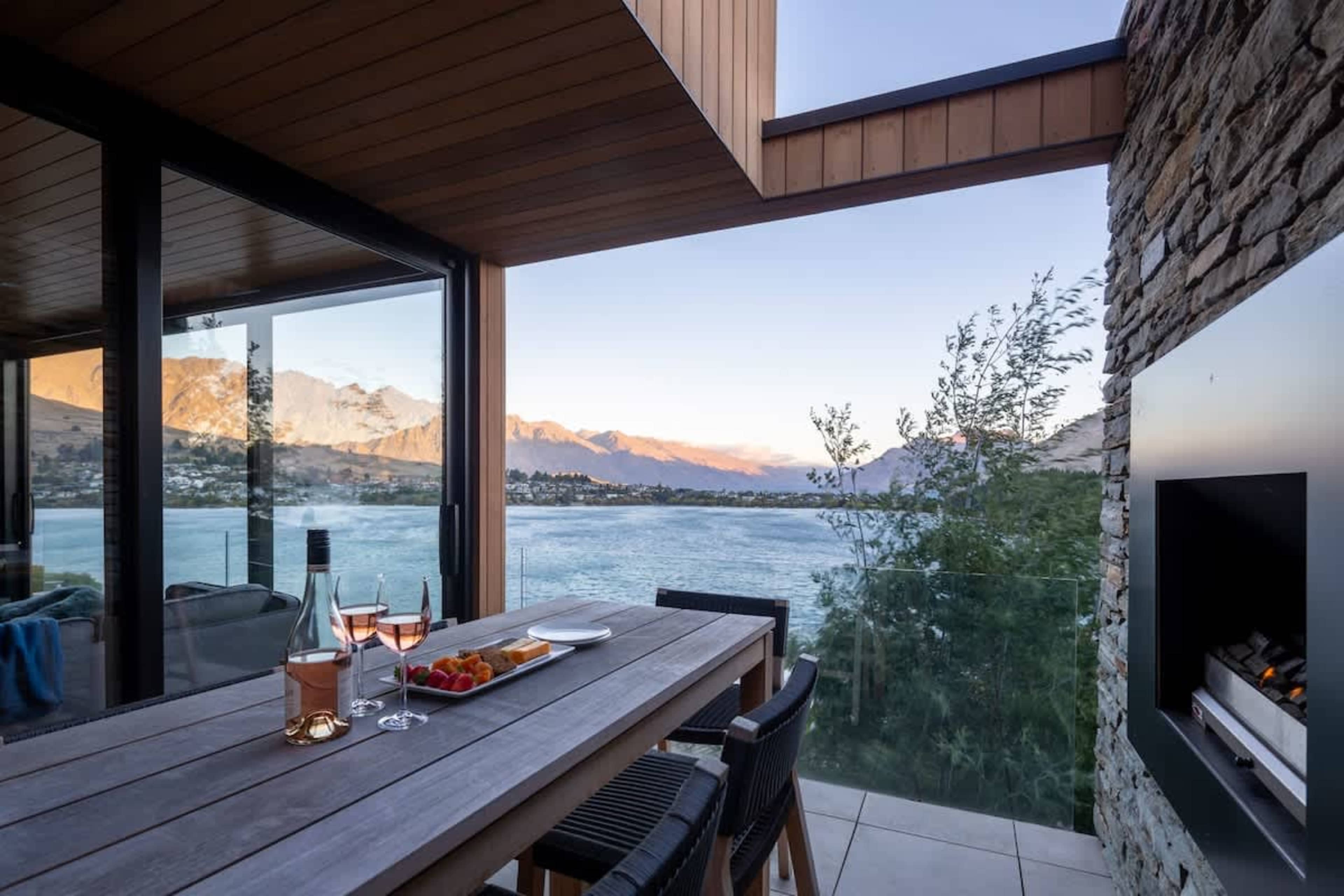 Private Patio with Fireplace and Stunning Views – Relax on the patio by the cozy fireplace, taking in breathtaking views of the lake and mountains for a perfect outdoor retreat.