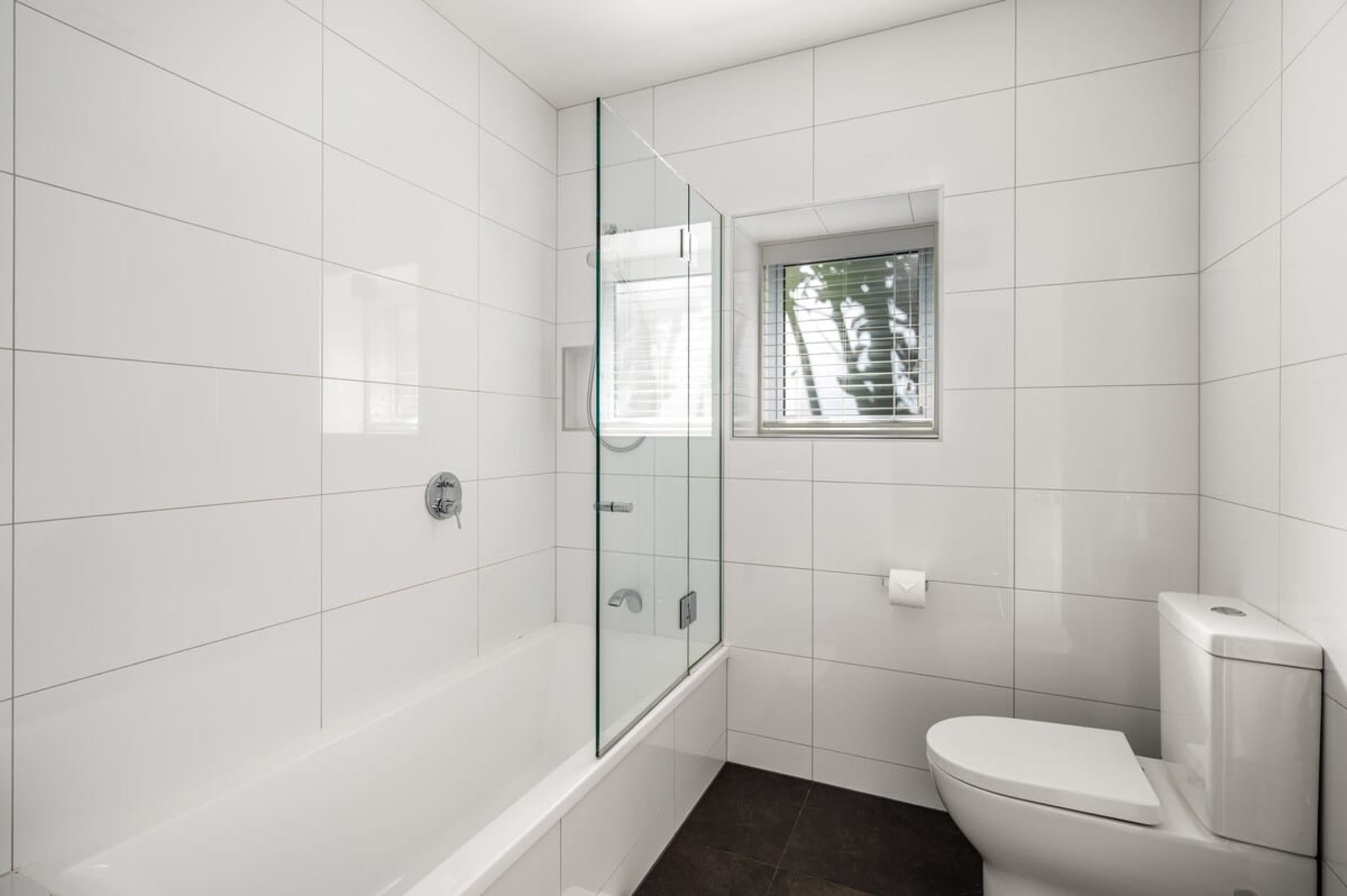 Indulge in luxury with a modern ensuite featuring heated floors, Ashley & Co. toiletries, and hotel-quality linen—perfect for your Queenstown retreat.