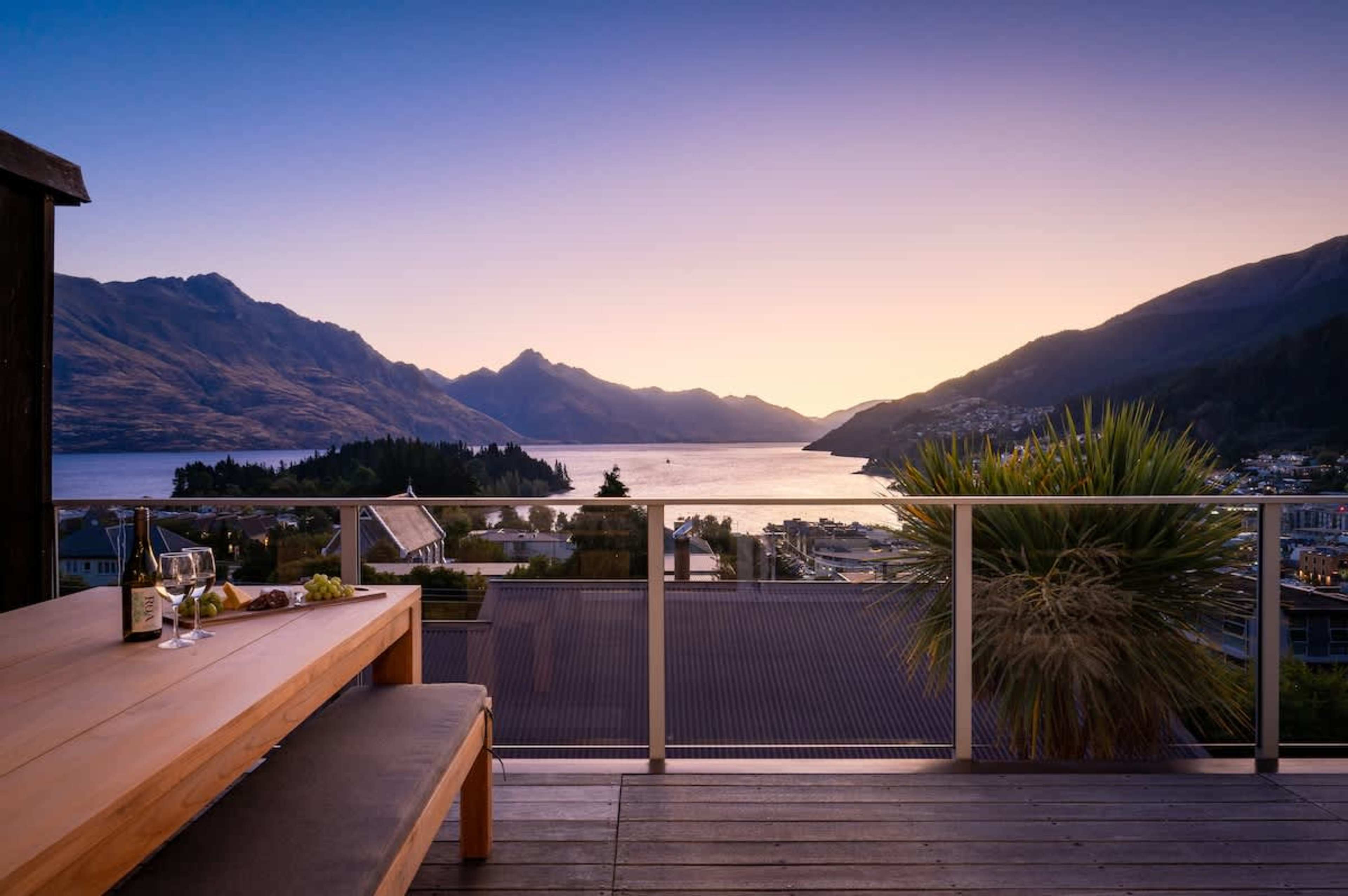 Al fresco dining on the main deck, complete with a BBQ and breathtaking views of Queenstown’s lake and mountains—ideal for sunset evenings.