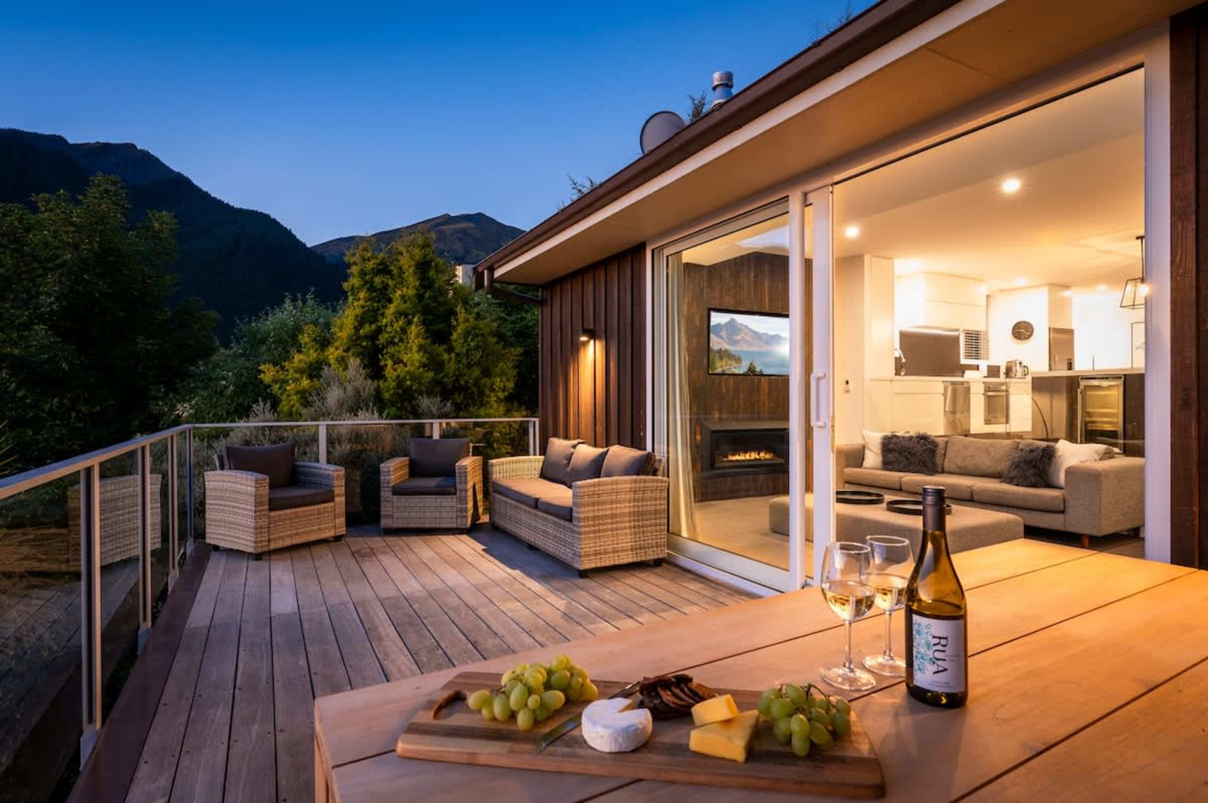 Stunning main deck with BBQ, offering panoramic views of Lake Wakatipu and The Remarkables—perfect for outdoor dining and relaxation.