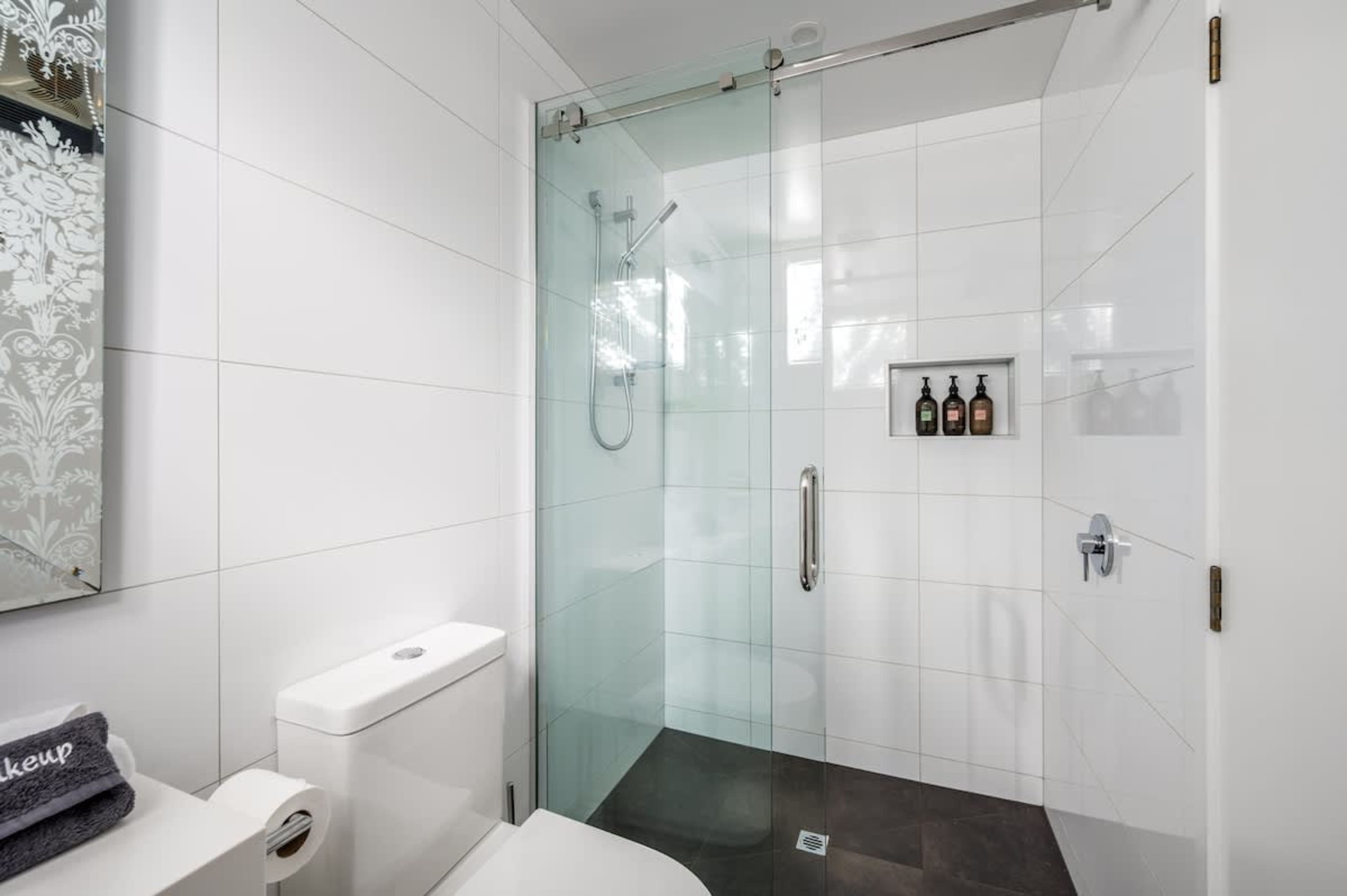 Elegant second bathroom with heated floors, hotel-quality linen, and Ashley & Co. toiletries—luxury and comfort for your Queenstown stay.