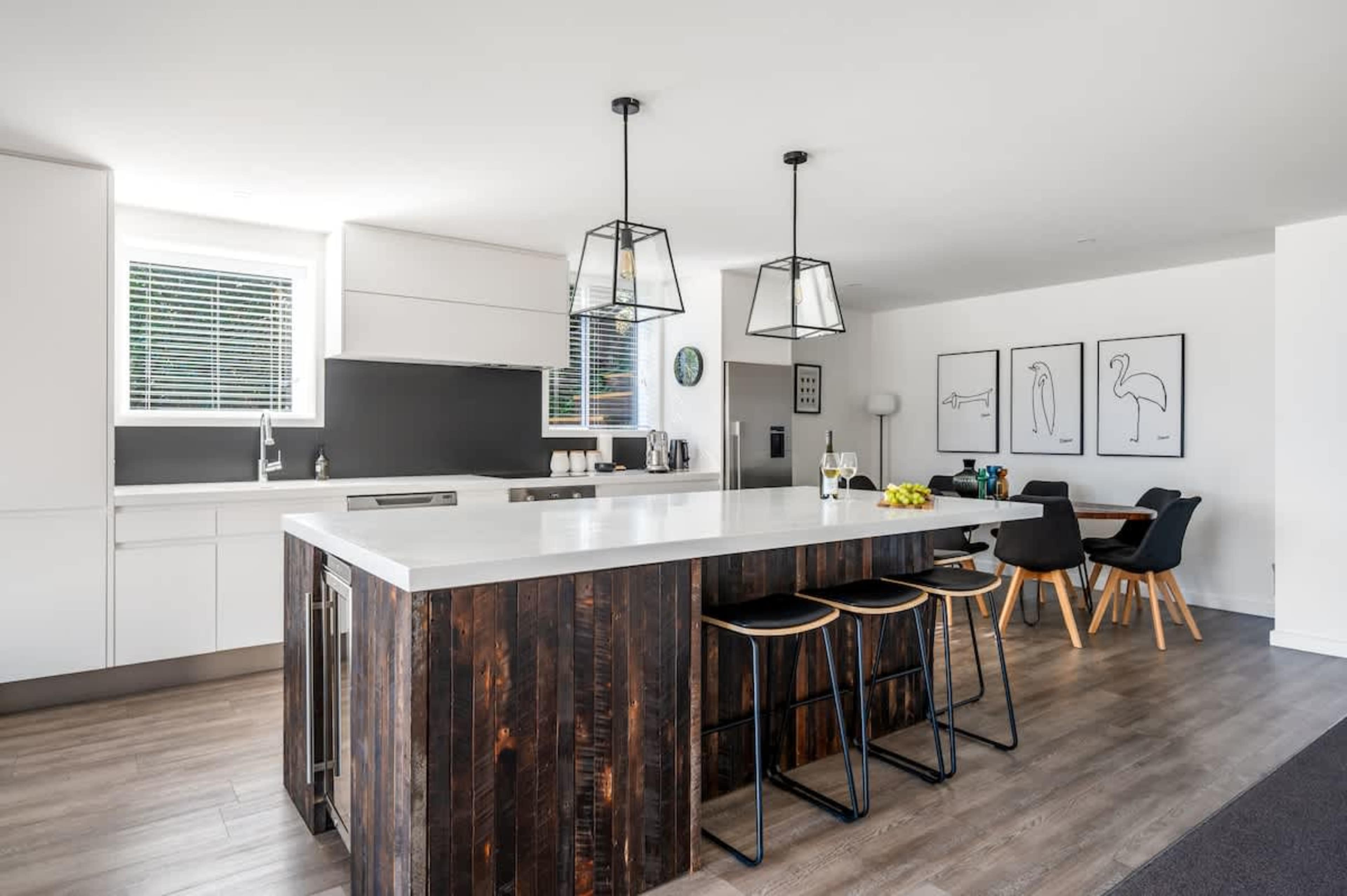 Cook up a storm in this fully equipped Queenstown kitchen featuring a coffee machine, modern appliances, and alpine views.
