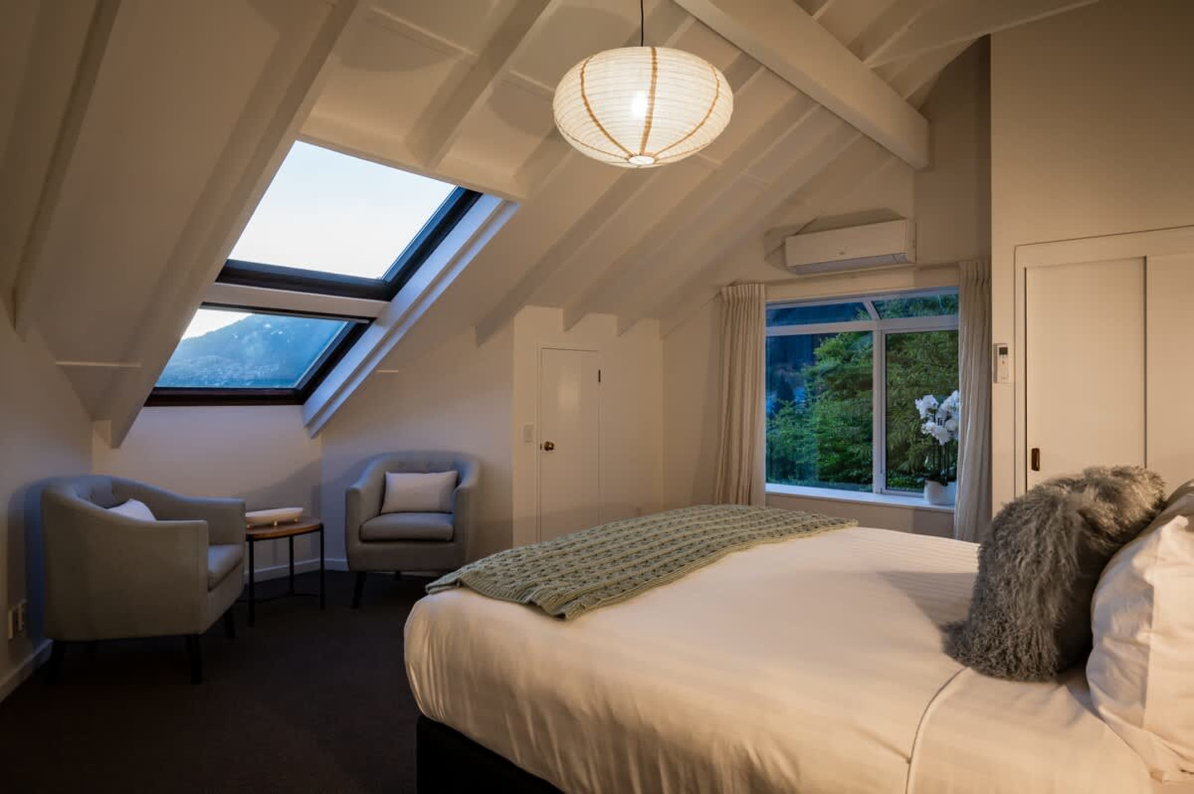 Elegant master bedroom with ensuite, ideal for couples exploring Queenstown wineries, ski fields, and scenic trails.