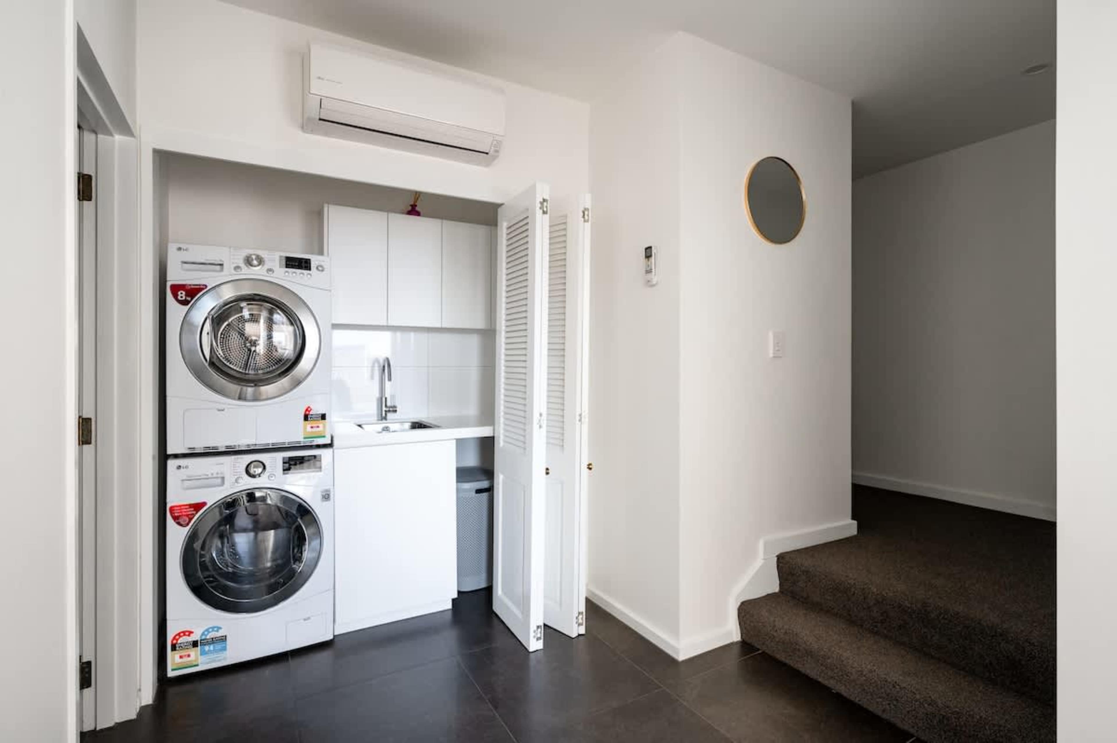 Convenient laundry area with modern appliances, ensuring a hassle-free stay during your Queenstown adventure.