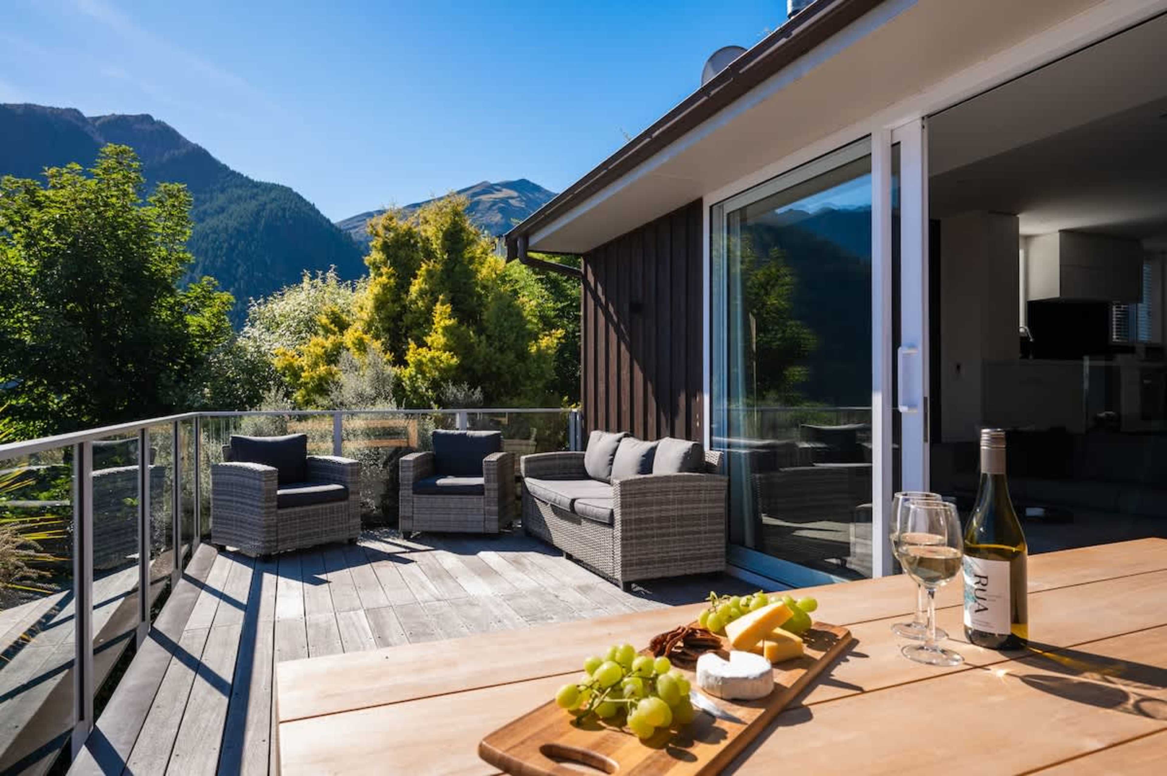 Alfresco living at its finest—main deck with sweeping views of Queenstown’s iconic lake and mountain range.