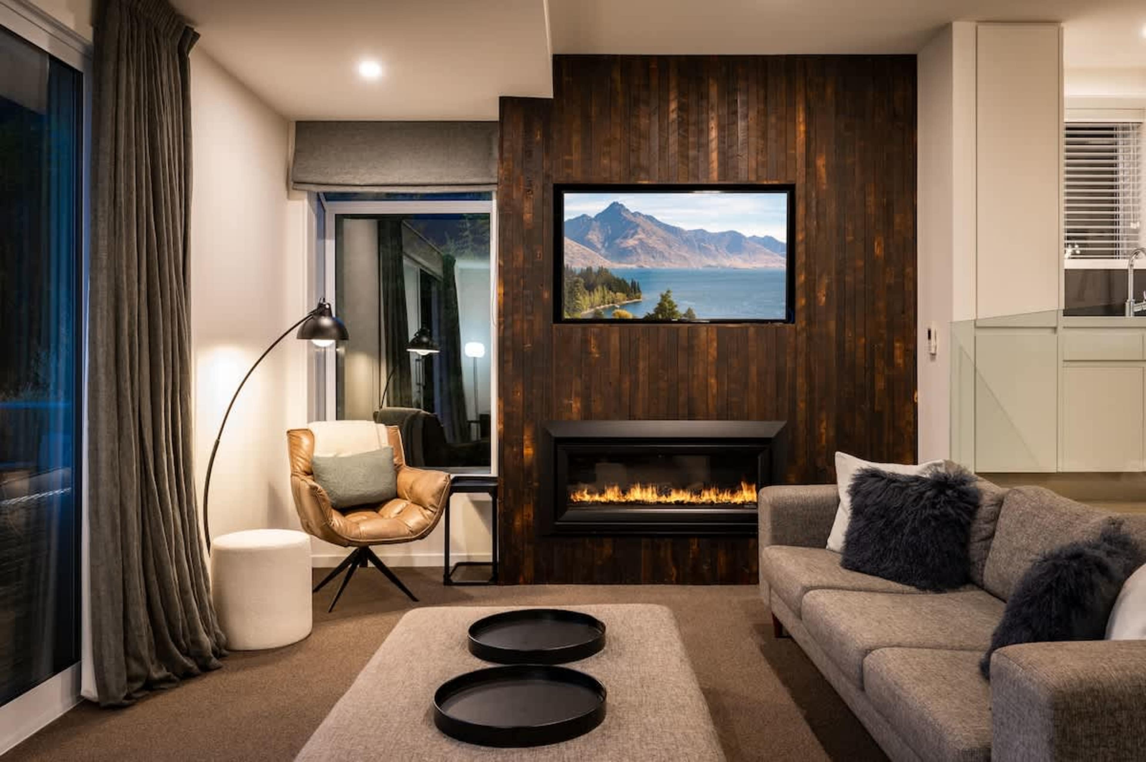 Unwind beside the gas fireplace in this stylish Queenstown retreat with breathtaking views of Lake Wakatipu.