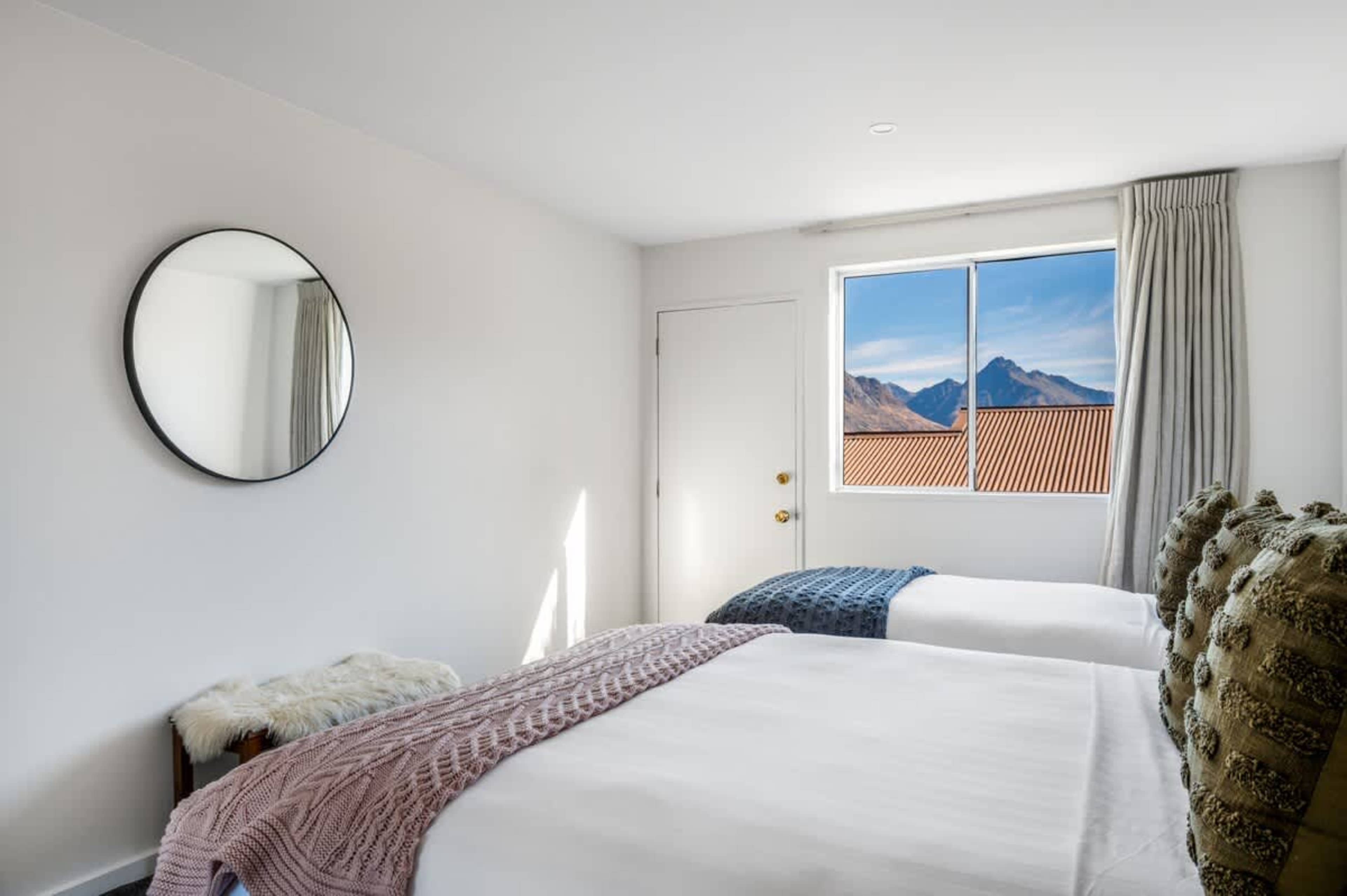 Comfort meets convenience in this light-filled room with flexible bedding and plenty of storage—perfect after Queenstown adventures.