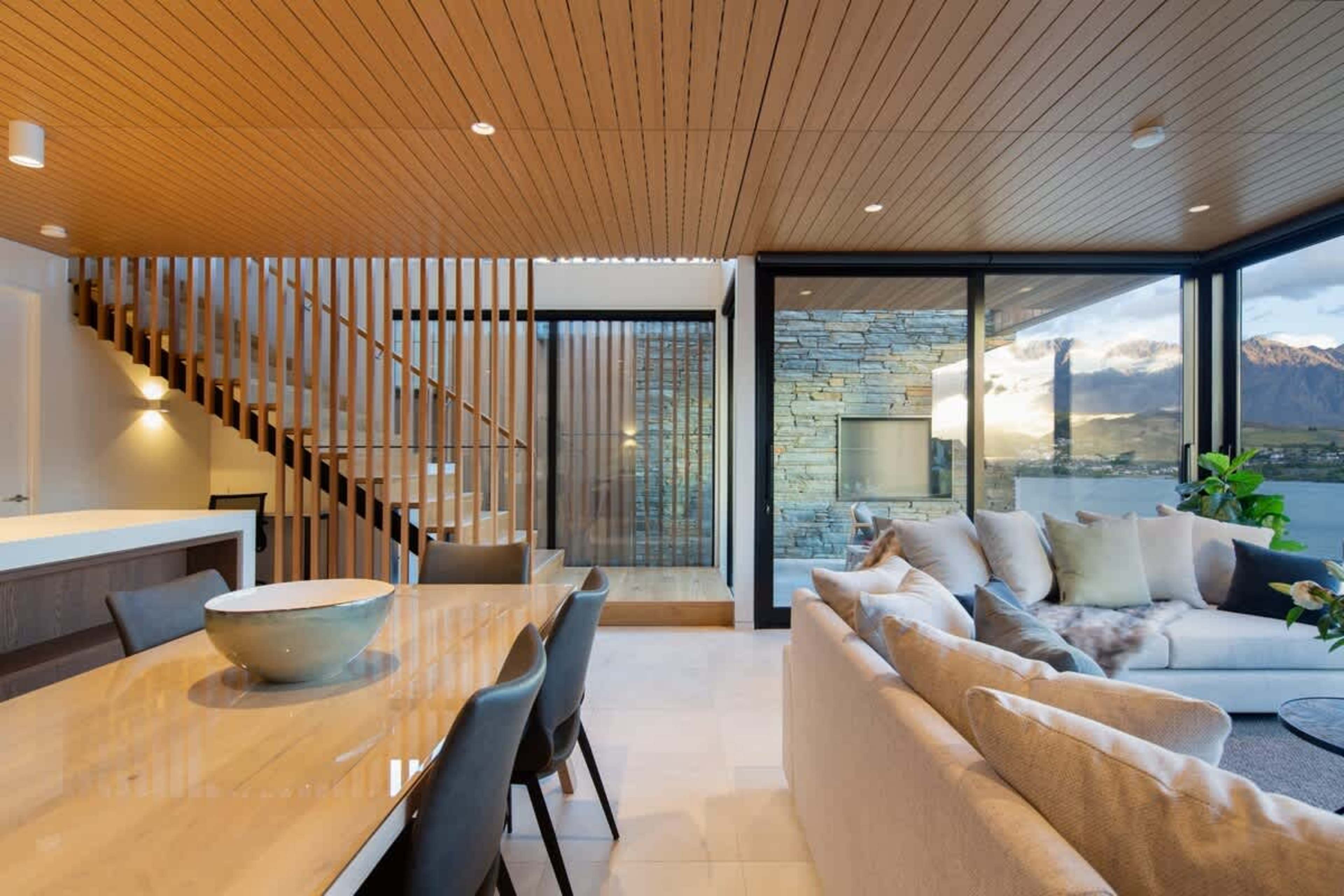This modern dining area offers a blend of luxury and practicality, with a spacious table, designer chairs, and large windows showcasing breathtaking views. Ideal for enjoying meals while taking in the natural beauty around you.