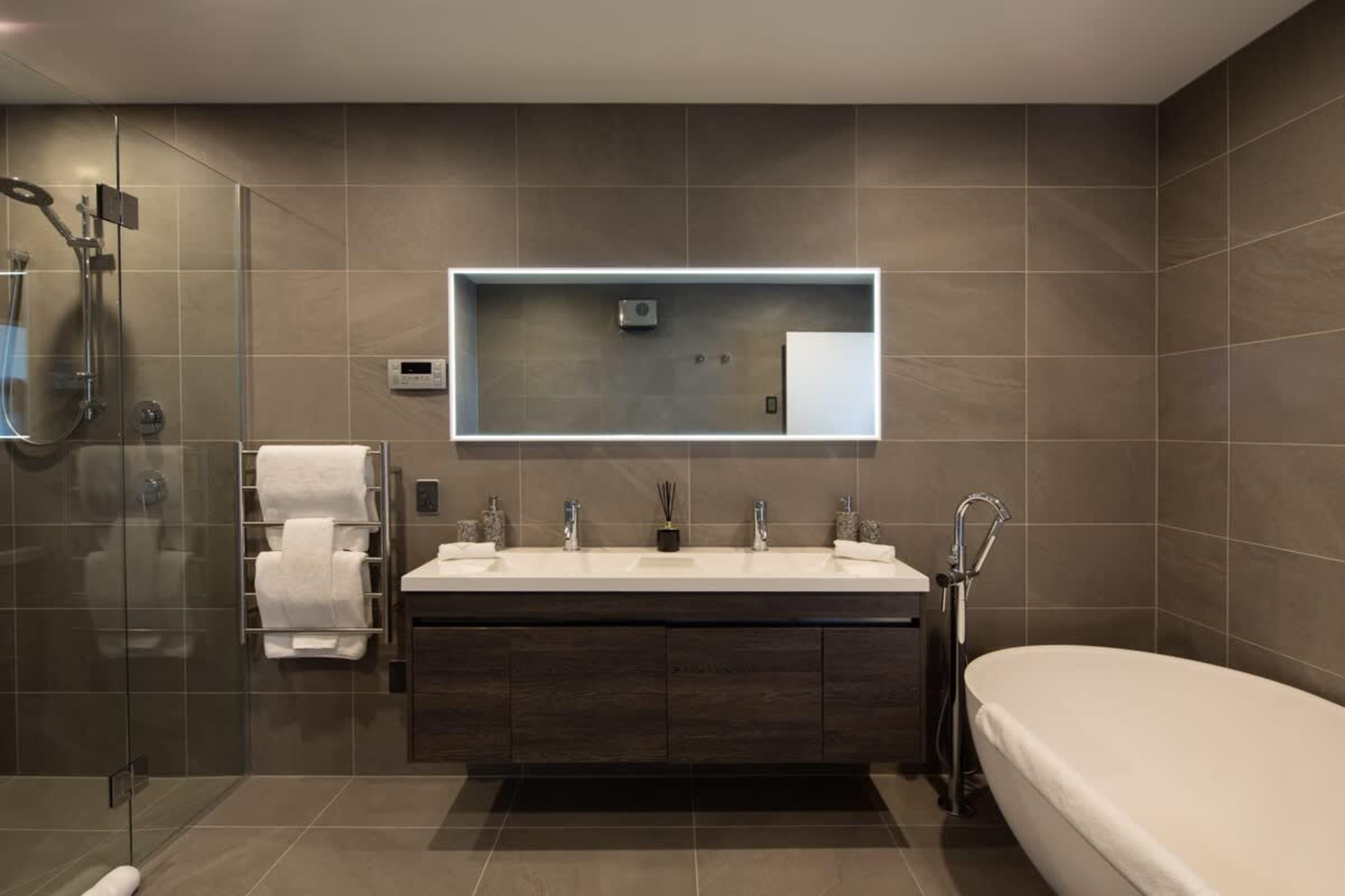 
Ensuite with Heated Floors
Indulge in this stunning master ensuite, complete with a spa bath for relaxation and heated floors for year-round comfort. The sleek design and luxurious finishes create a tranquil, upscale space perfect for rejuvenation.