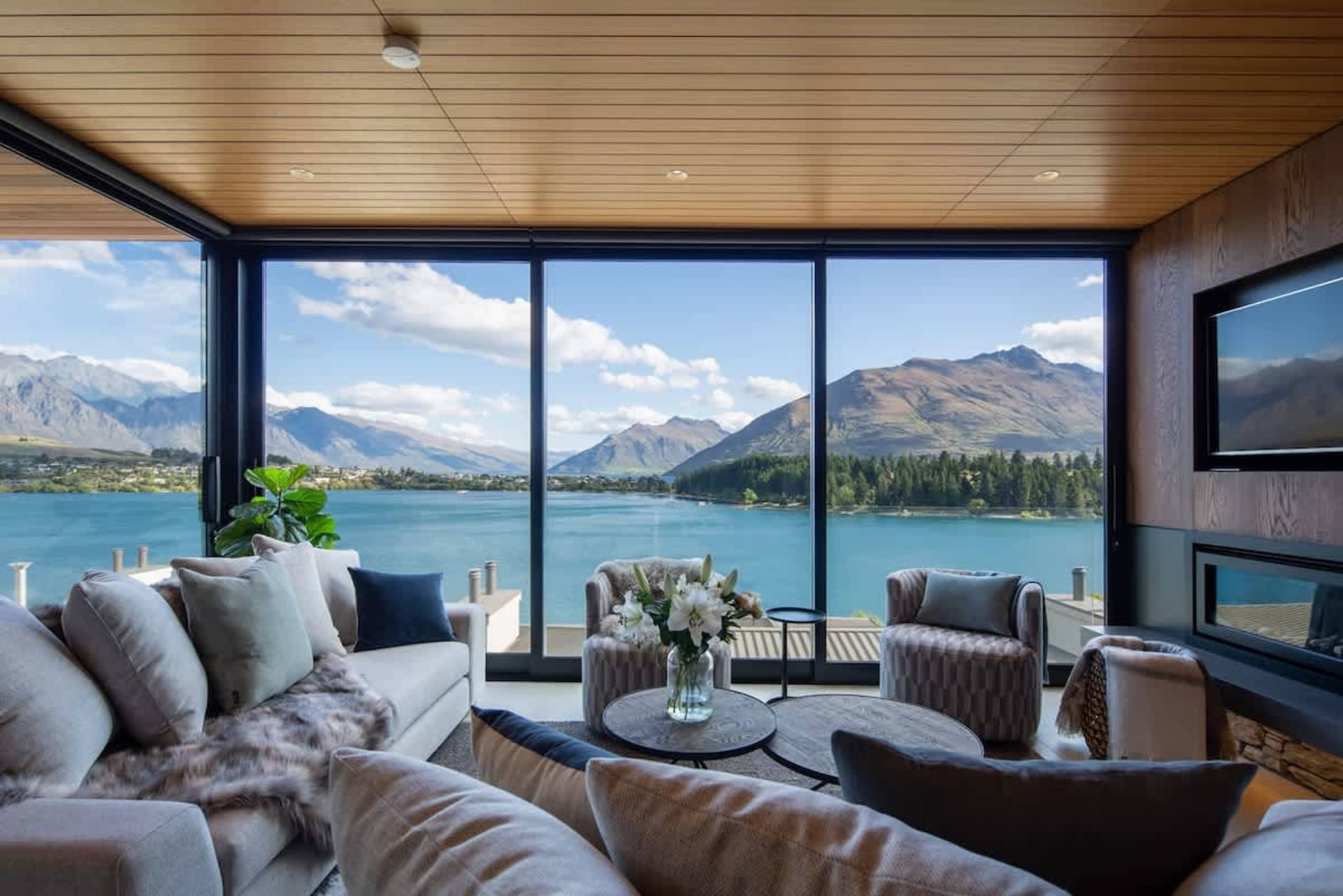 Lake & Mountain Views
Enjoy stunning views of Lake Wakatipu and the Remarkables from this expansive living room with floor-to-ceiling windows. Relax on the plush sectional sofa by the gas fireplace in winter or stay cool with efficient AC.