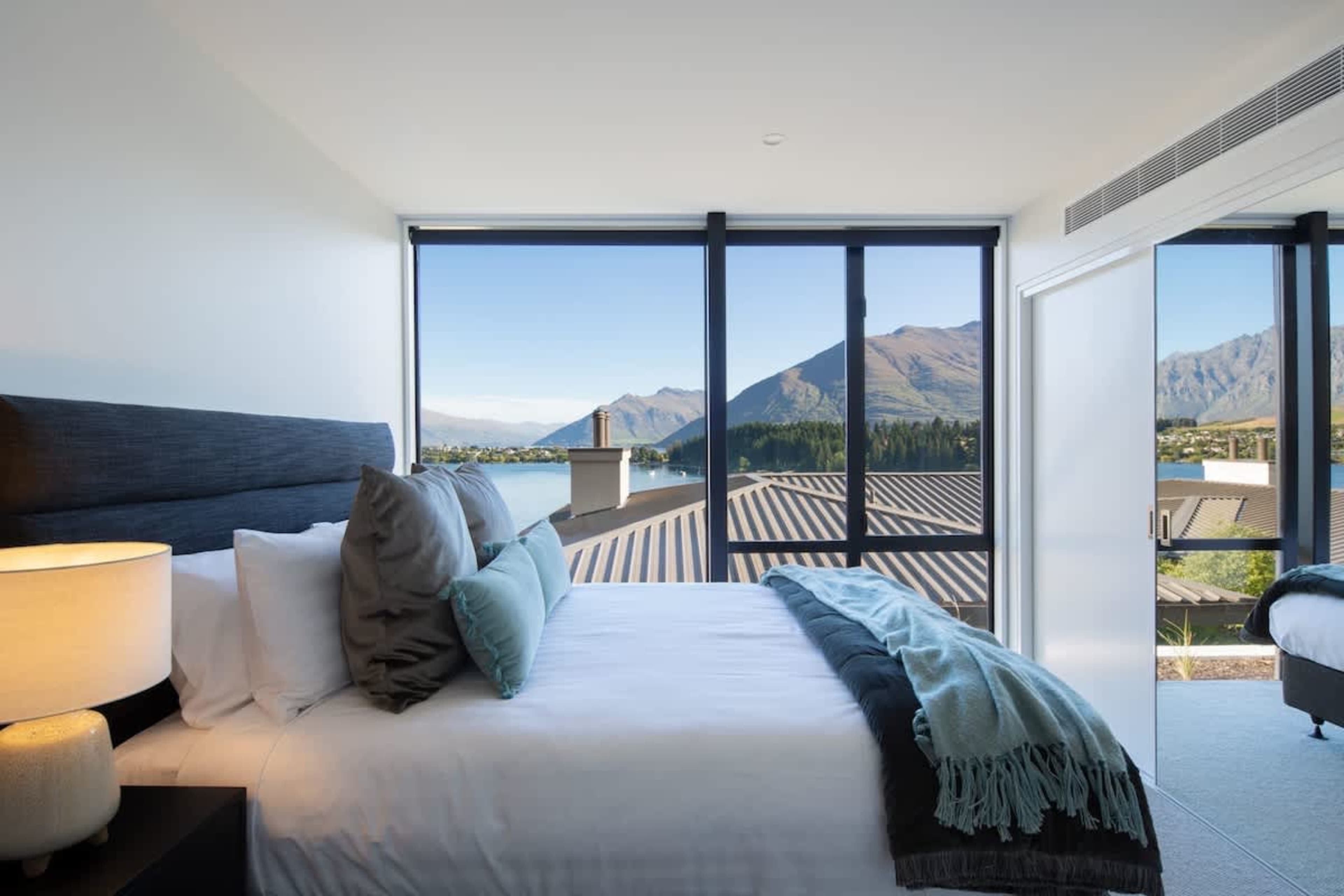 The master bedroom offers ultimate comfort with a plush king-sized bed, a private ensuite featuring premium fixtures, and a spacious walk-in wardrobe. Wake up to breathtaking lake and mountain views through expansive windows, creating a serene escape