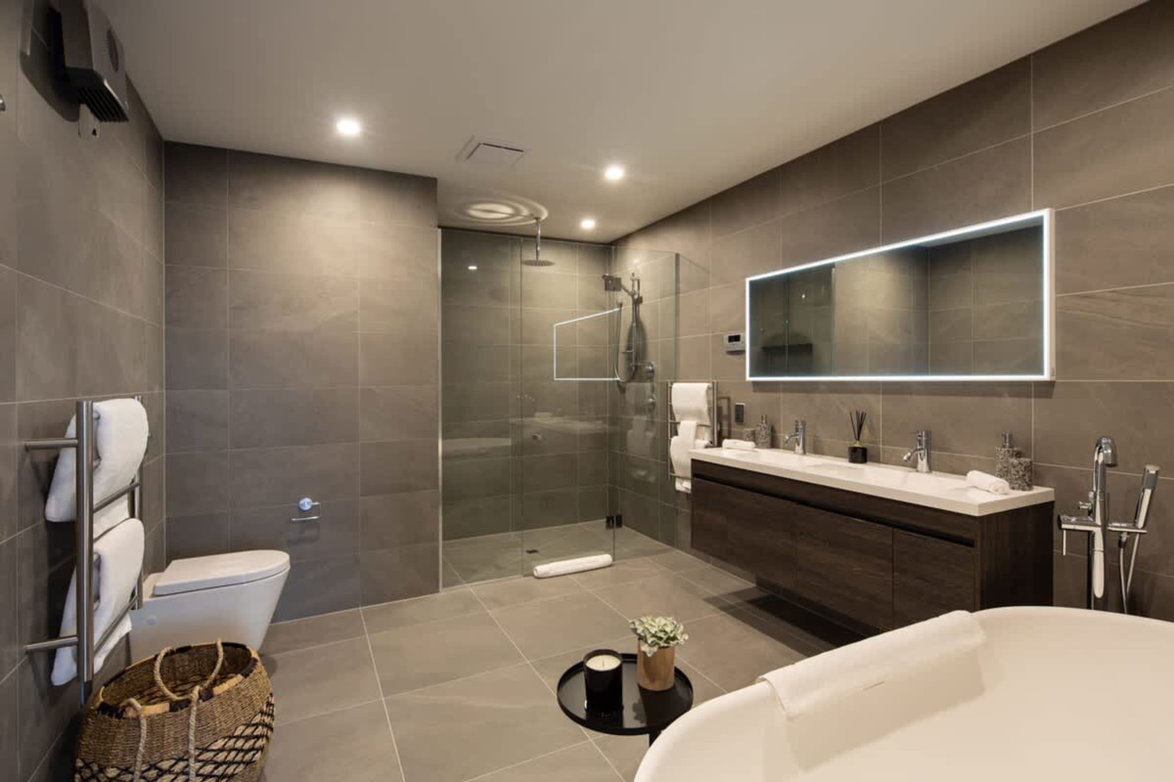 This luxurious master ensuite features a spa bath for ultimate relaxation, complemented by heated floors for added comfort. High-end finishes and elegant fixtures create a serene, spa-like atmosphere, making it the perfect place to unwind.