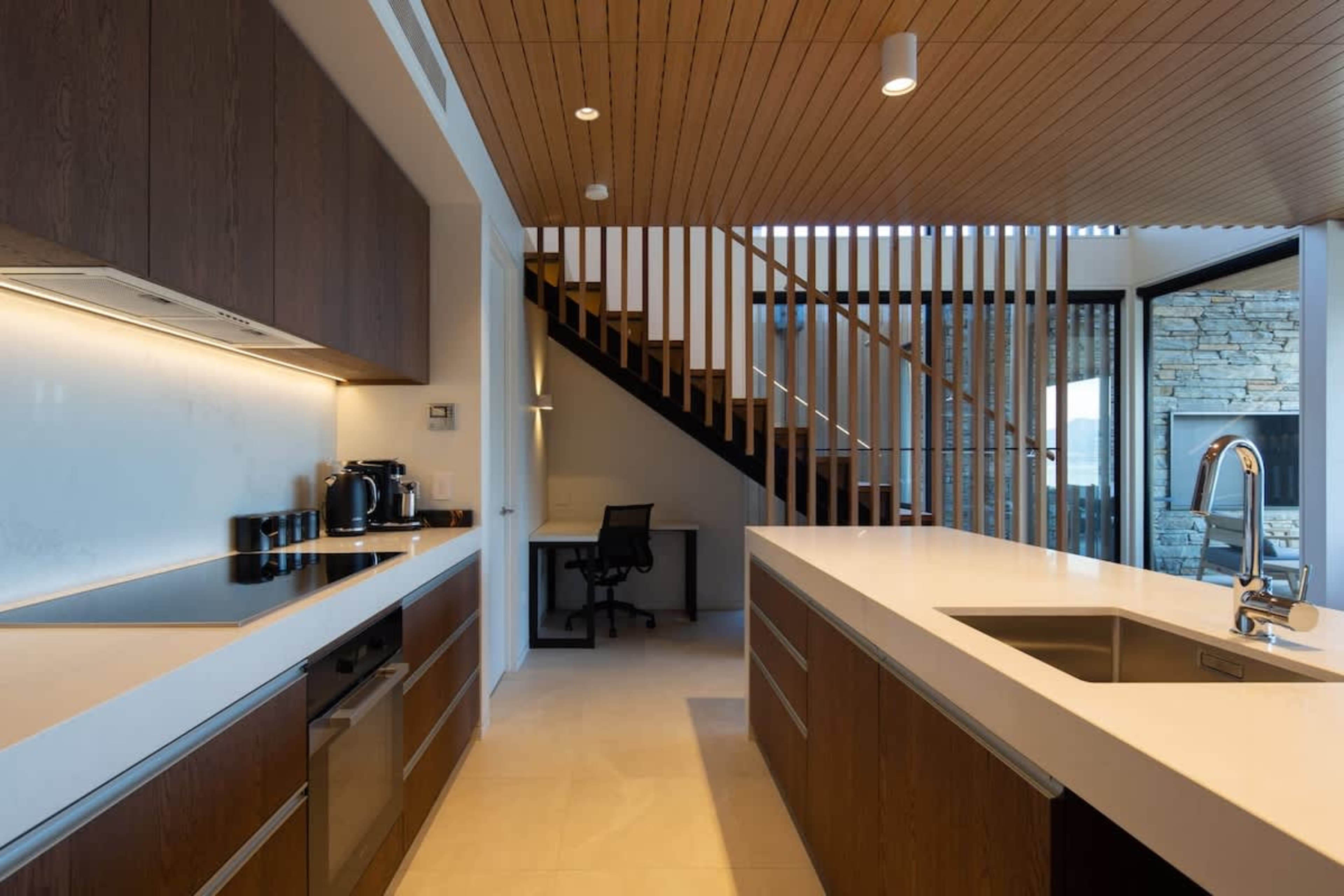 Modern Gourmet Space
This sleek, fully equipped kitchen features high-end appliances, a spacious island, and ample storage. Large windows provide natural light, with scenic lake and mountain views adding to the ambiance.