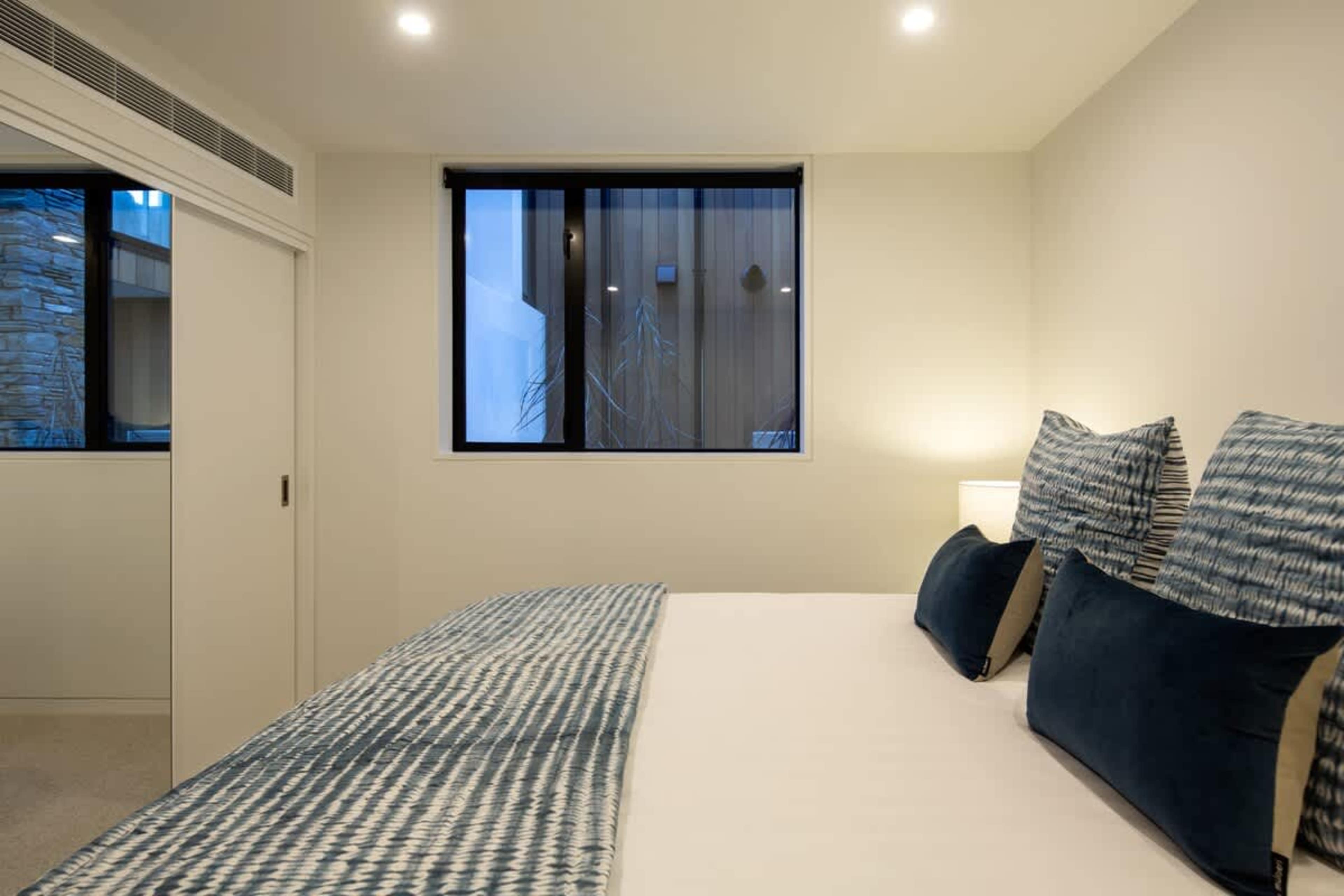 Relaxing Bedroom
A tranquil space with a king-sized bed, stylish decor, and ample natural light. The fourth bedroom offers breathtaking lake and mountain views, making it the perfect retreat for guests seeking both comfort and scenic beauty.