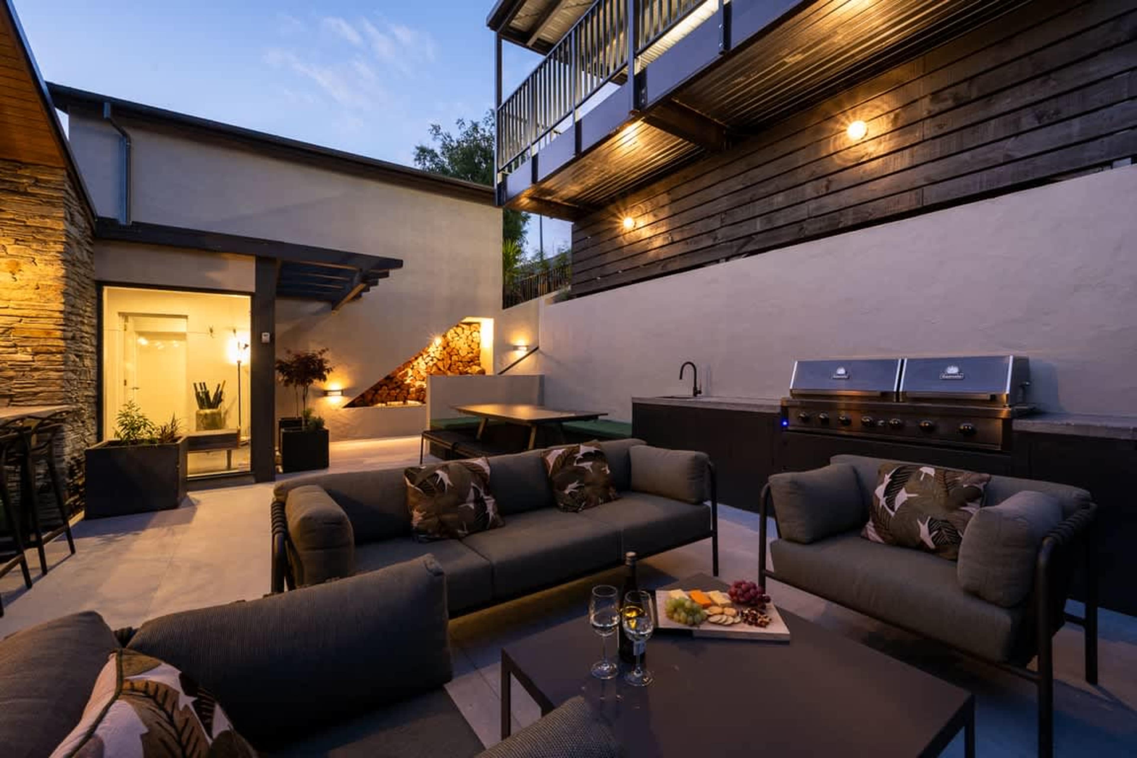 Indoor-Outdoor Dining Cook in the sleek, modern kitchen and step out to the patio with an outdoor fireplace—perfect for alfresco dining in Queenstown.