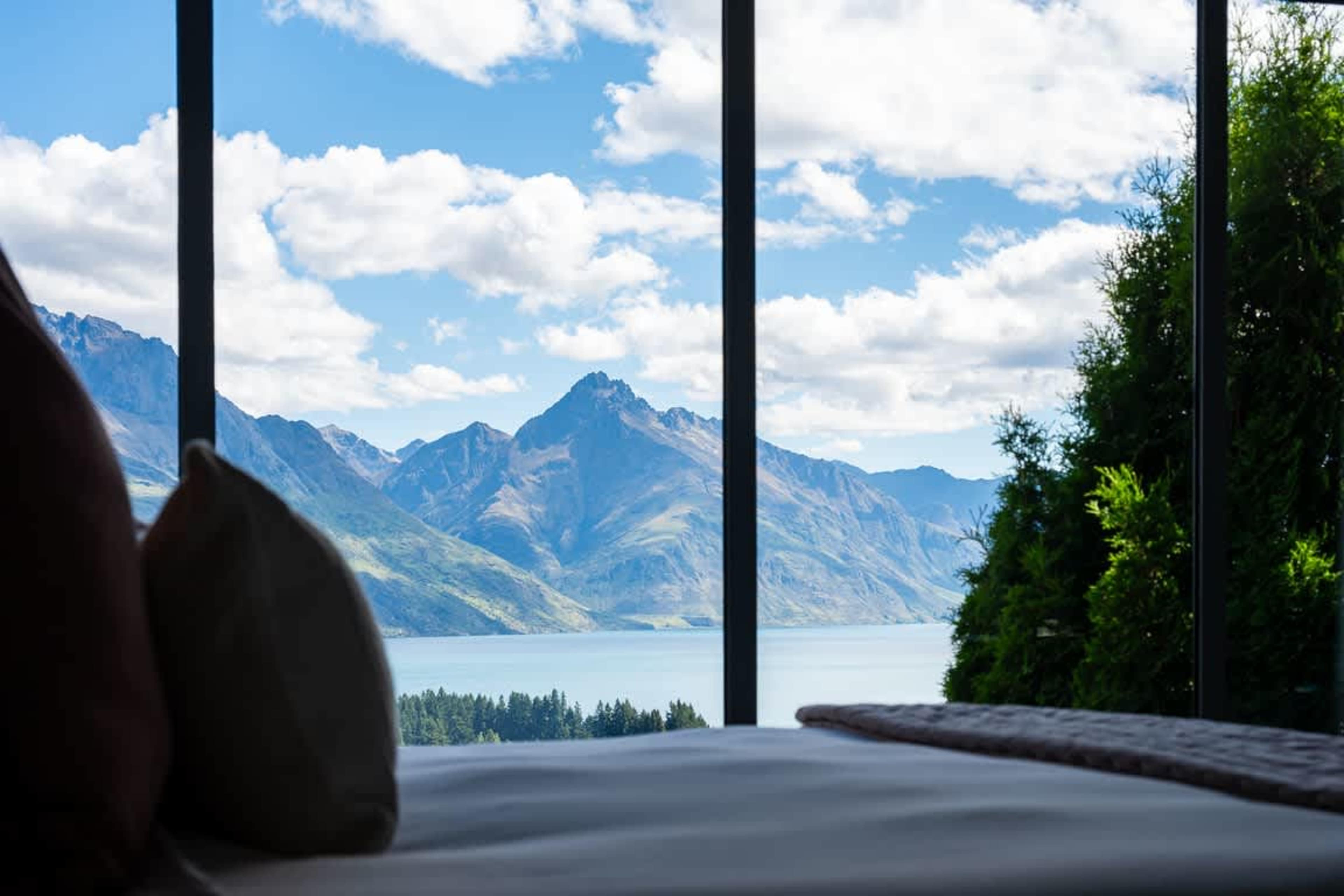 Room with a View The master bedroom offers unparalleled lake and mountain views, complemented by a sleek ensuite for a premium experience.